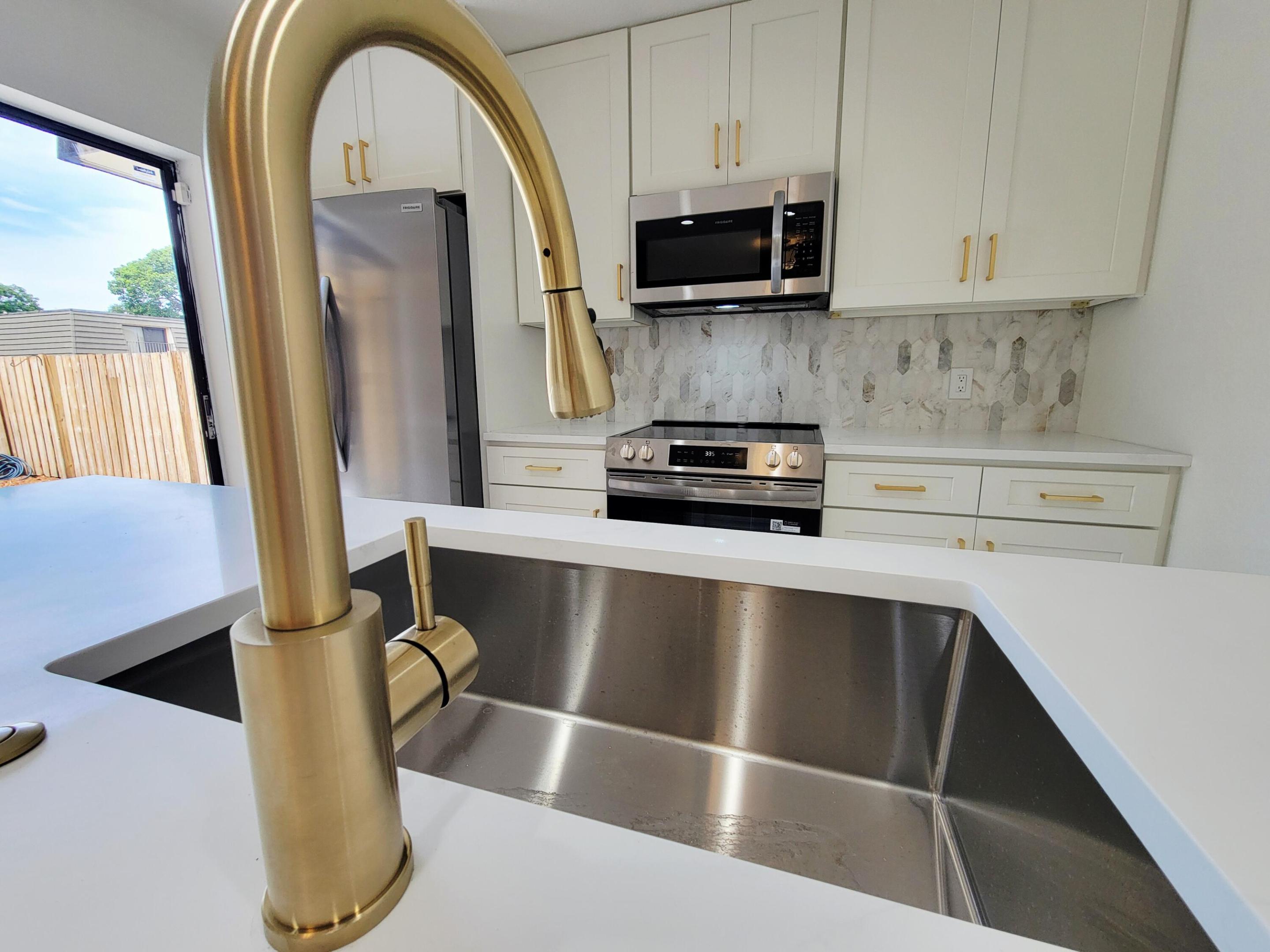 If you're looking for a townhome with everything new, this is the one! New fixtures, flooring , cabinetry, trim and more. This newly renovated townhome will not disappoint! All new 3/4'' solid kitchen cabinets and vanities with quartz and Calcutta tops. Flooring in main areas is 100% waterproof with a 40 year warranty. The master bath is outfitted with double sinks and a frameless shower enclosure with modern fixtures.  Accordion shutters for all openings.! Call Glenn for a showing ...this won't last!