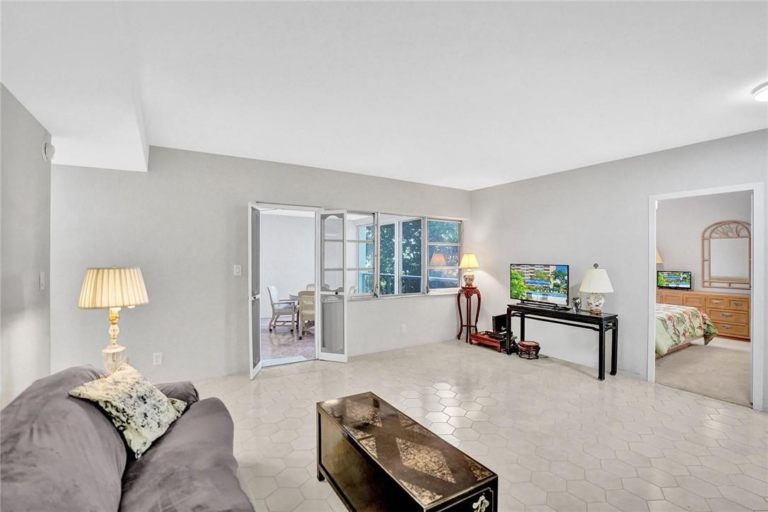 This large and bright, 2 bedroom, 2 bathroom unit is ready to welcome you home. You will be pleased to know that there are many great updates to this unit. The hot water heater, electrical panel, AC, plumbing, and electrical have all been upgraded in 2021. The open floor plan features a large enclosed porch that can be utilized as a great bonus  living space and also features ample closet storage. The Coral Ridge Towers East building is working hard to complete a luxurious renovation for their shareholders. You are within walking distance to the beach, shopping, dining, entertainment, and more while residing at this cooperative community designed for persons aged 55 years of age and older. Don't miss an opportunity to call this rarely available corner unit your new home.