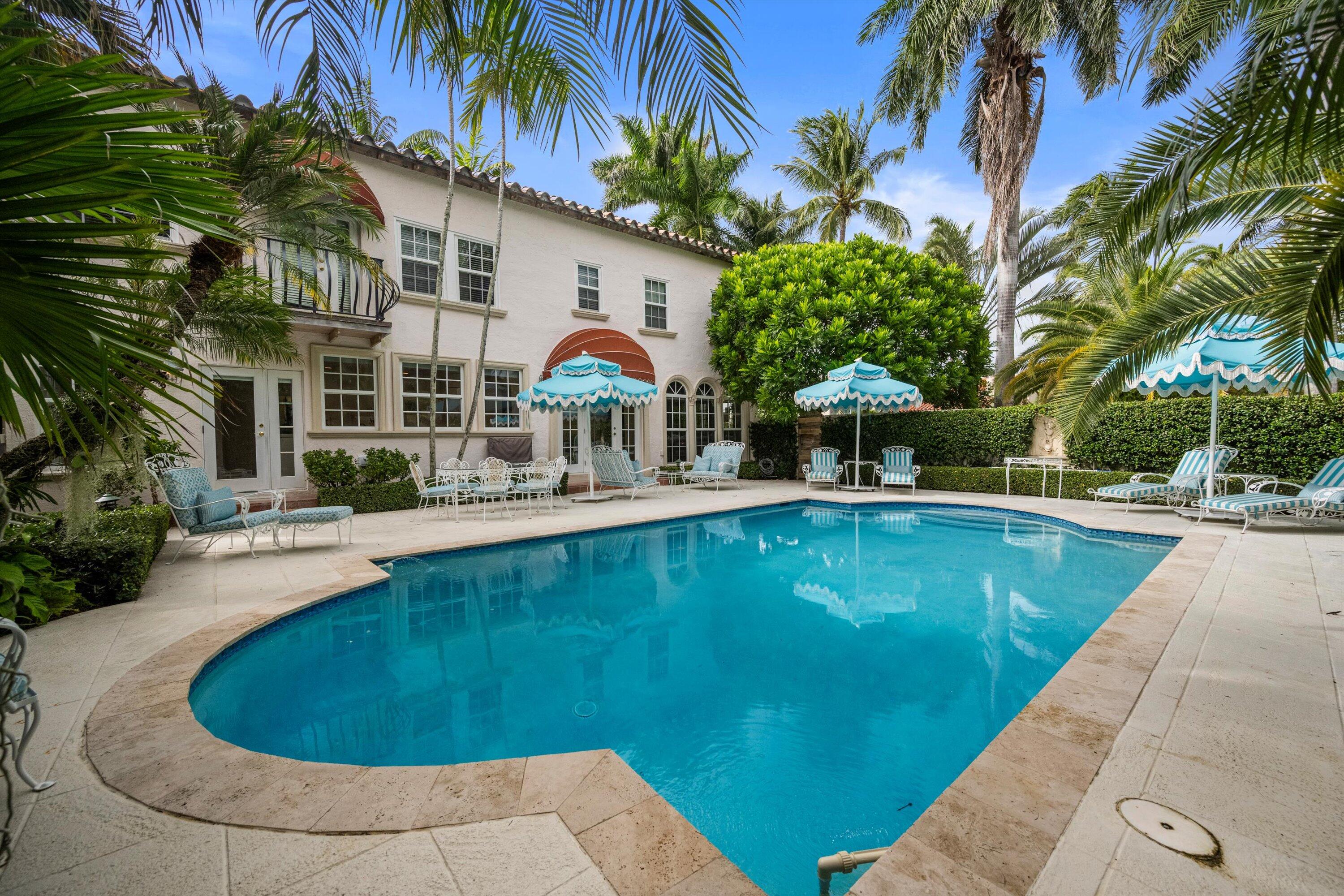 This elegantly casual in-town 3BR/3.5BA home on a rare double lot features original architectural details, high ceilings, wide plank floors, and a pecky cypress-paneled family room. A 1BR/1BA guest suite sits above the two-car garage. Enjoy an exceptional resort-style pool/patio area surrounded by lush landscaping—perfect for entertaining and relaxing. Meticulous renovations include hurricane impact windows, a gourmet chef's eat-in kitchen, and updated baths. Located on a quiet, desirable ''Sea'' street with beach access, near schools, the Palm Beach Rec Center, tennis courts, and Society of the Four Arts.