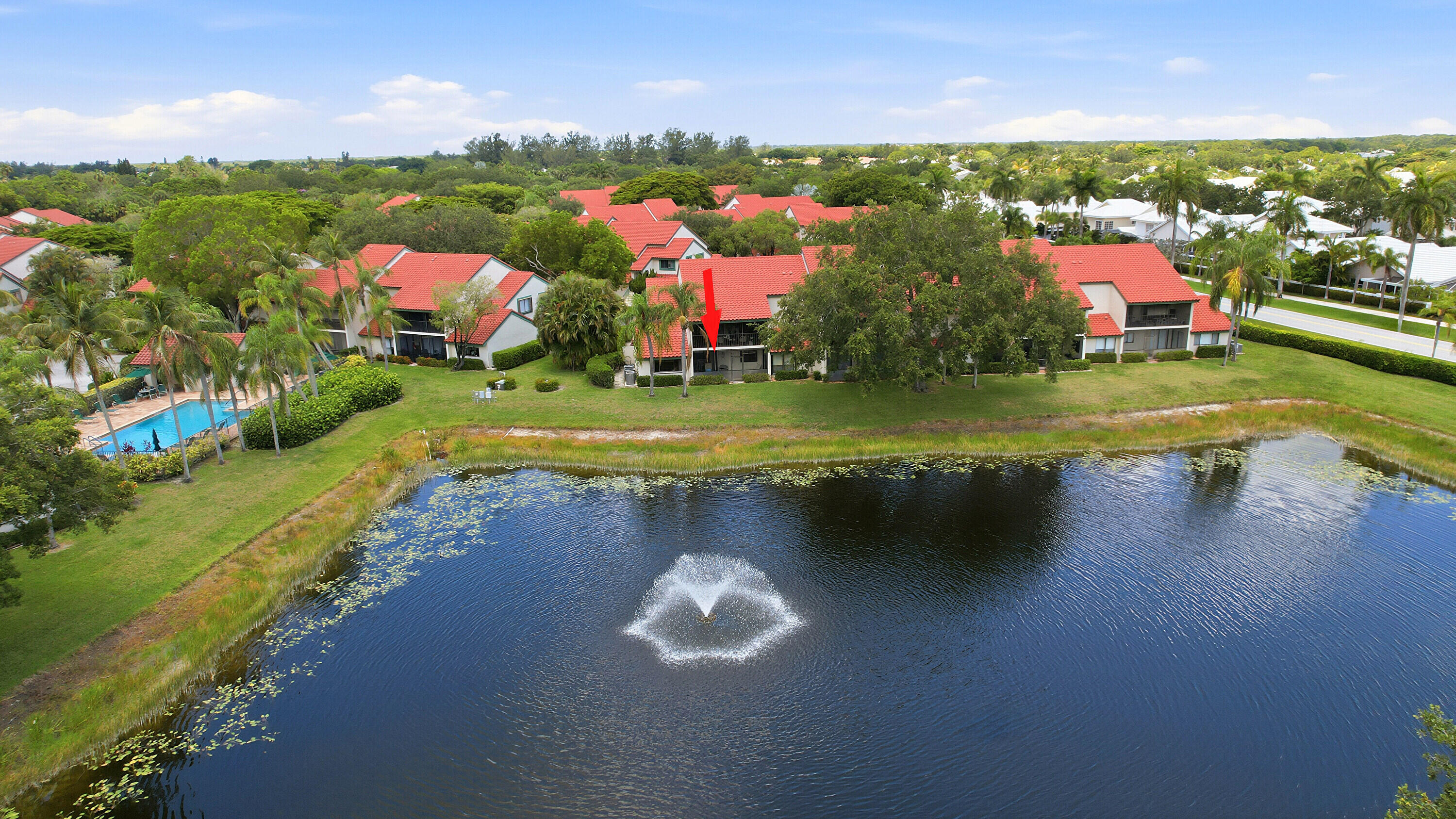 Discover the perfect blend of resort-style living and serene waterfront tranquility at PGA National, Palm Beach Gardens, FL This fabulous first-floor end-unit condo in Lexington Green is priced to impress! This 2-br, 2-bath, 1,400-SF one-level residence offers unparalleled lake and fountain views, making it a true standout in one of South Florida's most prestigious communities. Step inside to an open living and dining area that flows seamlessly to the screened patio overlooking the sparkling lake—perfect for morning coffee, sunset gatherings, or simply relaxing to the fountain's gentle splash. An attached garage adds convenience and storage. enjoy Lexington Green's community pool and sundeck, plus PGA National's world-class amenities: championship golf (optional), miles of trails and    tennis, fitness, and resort-style living. Low HOA  cover maintenance for worry-free ownership.  Lock the door, close the accordion shutters and head for the Airport!  Just minutes from The Gardens Mall, beaches, dining, and PBI Airport, this lakefront gem is ideal as a primary home, vacation retreat, or investment. One-level living, end-unit privacy, and stunning views make it truly special. Schedule your showing today!