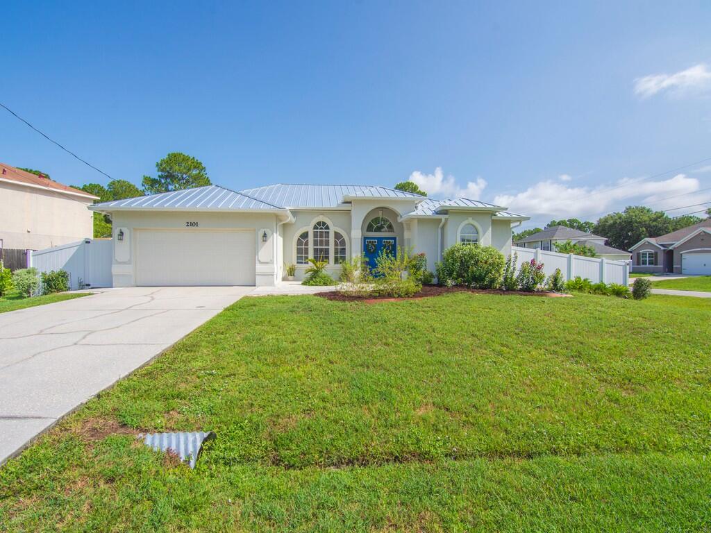 Just Listed! Embrace the laid-back coastal lifestyle in this spacious 3-bedroom, 2.5-bath home, conveniently located just minutes from I-95. Designed for comfortable living, this home features both a living room and a separate family room, giving everyone plenty of space to spread out. The bright, inviting kitchen offers a convenient breakfast bar, making it the perfect spot for casual meals, morning coffee, or entertaining guests.  Step outside to your own private retreat with a fully fenced backyard, a sparkling pool, and a screened lanai with brand-new screens—ideal for relaxing and enjoying Florida's outdoor lifestyle. A brand-new roof adds peace of mind, while the home's beachy vibe makes it feel like a year-round getaway.