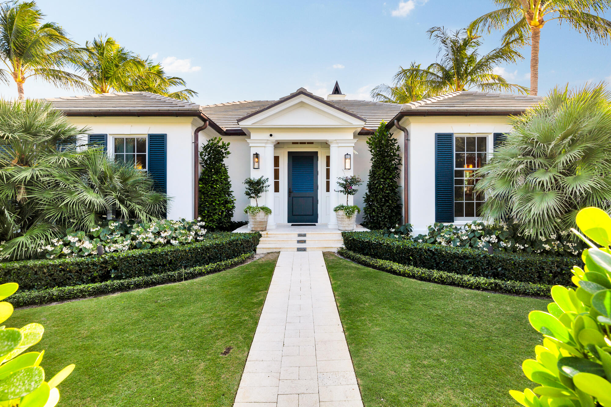 Exquisite Bermuda-style residence completed in 2018 and positioned on high elevation (9'+), just moments from the beach. This refined designer home offers 5 bedrooms and 6.2 baths within a thoughtfully crafted floor plan.

An open-concept kitchen and family room overlook serene pool and garden views. The chef's kitchen features a large island, Wolf and Sub-Zero appliances, and custom birch cabinetry, ideal for both daily living and entertaining.

Additional highlights include 8-zone climate control including the 2-car garage, whole-house generator, and impact-resistant windows, delivering comfort, security, and effortless Palm Beach living.