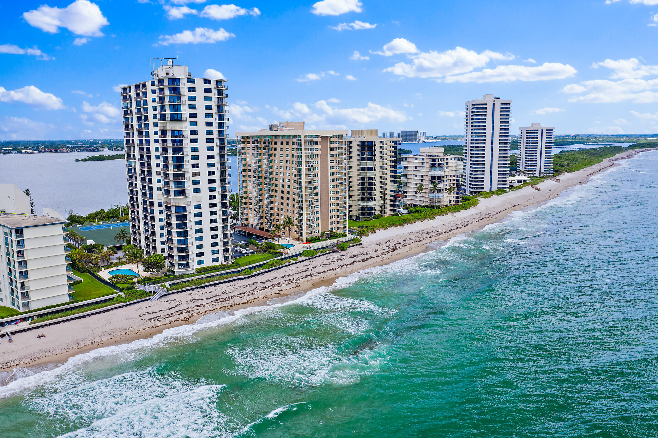 Enjoy the sparkling turquoise blue water & put your toes in the sand just steps away from your front door! This condo offers a gorgeous open floorplan boasting luxurious coastal living from the sleek modern kitchen w/SS appliances & quartz countertops to the wide-plank flooring throughout. WASHERS/DRYERS ARE ALLOWED IN THE UNIT! Ocean & Intracoastal views can be enjoyed off the wrap-around balcony; enjoy water views from almost every room where the sound of the waves will become your daily soundtrack! Perfect for full-time living or a luxury getaway, you will enjoy the coastal residence that combines comfort, functionality and is perfectly located! Extra storage and garage parking are just a couple of the perks in a renovated building that is loaded with resort-style amenities! You will enjoy 800' of private beach, your own seawall and a financially secure bldg. Bring offer and start living the oceanfront lifestyle you've dreamed of!