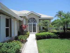 Sought after Divosta ''Hampton'' model, nice lake views and large tropical side yard.  Large Master Suite with loads of closet and storage space, Tile throughout living area, newer appliances include washer, dryer, stove, dishwasher, refrigerator and hot water heater.  Plantation shutters, neutral colors, accordion storm shutters, fully fenced.  Patio has been enclosed for versatile enjoyment.  Delightful maturely landscaped, guard gated community with sidewalks for strolling or bike riding, activity center including pool, playground, tennis and more.  A wonderful place to live.  Fees of only $272 per month. Close to everything!