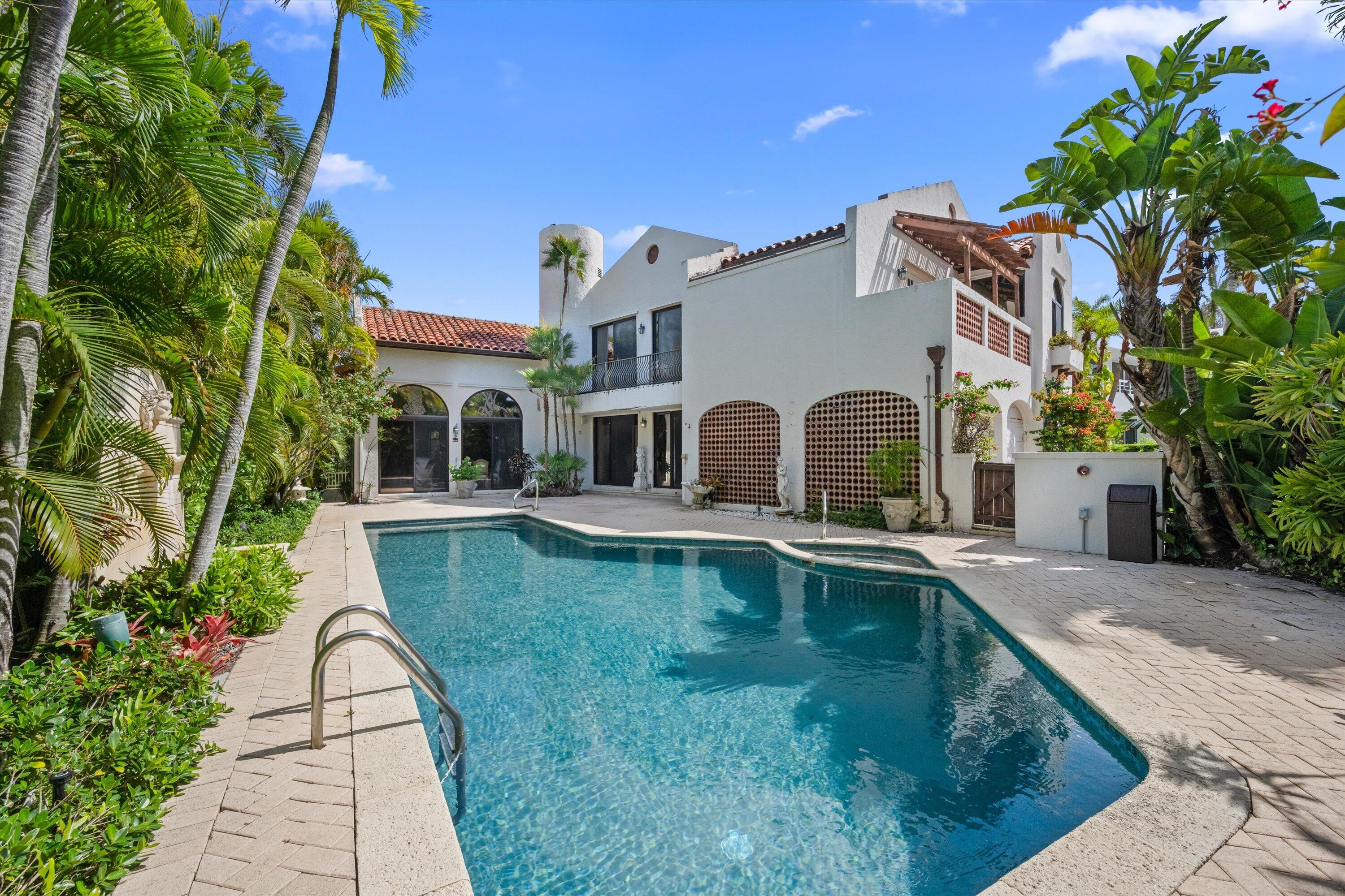 Set within one of Palm Beach's most prestigious oceanfront enclaves, 23 Sloans Curve presents a rare opportunity to reimagine a refined island residence of exceptional scale and privacy. Encompassing approximately 5,066 square feet, the four bedroom, four and a half bath home offers the comfort and presence of a private estate, complemented by full service community amenities and direct beach access. Generous interiors and expansive proportions provide an ideal canvas for transformation, with seamless flow to tranquil outdoor spaces framed by lush tropical surroundings—serene, secluded, and perfectly positioned for the Palm Beach lifestyle.