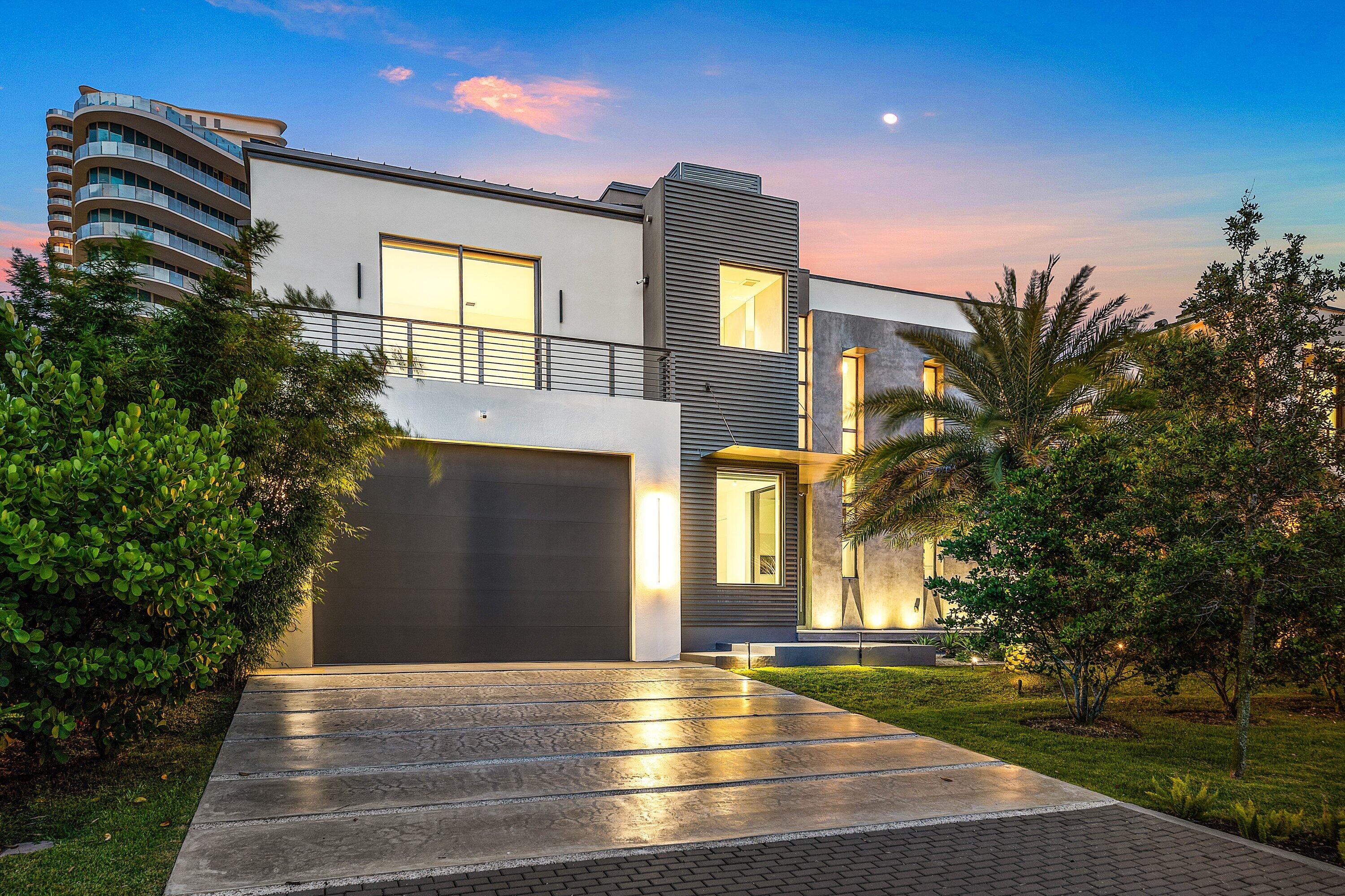 Experience modern waterfront living on gated Terra Mar Island in Lauderdale-by-the-Sea, complete with private beach access just 200 yards away. Developed by Bricker and designed by IntelAE, this exceptional residence offers 5 bedrooms, 4 full and 2 half bathrooms, and 75 feet of waterfront with private yacht dockage. Inside, dramatic 25-foot ceilings create an immediate sense of scale, while high-end Italian finishes, dual primary suites, motorized shades in every bedroom, a dedicated coffee bar, and wine refrigeration elevate everyday living. Solar power provides enhanced energy efficiency and independence throughout the home. Designed for seamless indoor-outdoor entertaining, the private backyard features a saltwater pool and spa, a fully equipped outdoor kitchen, and generous waterfront living spaces—creating a true resort-style retreat just moments from the beach.
