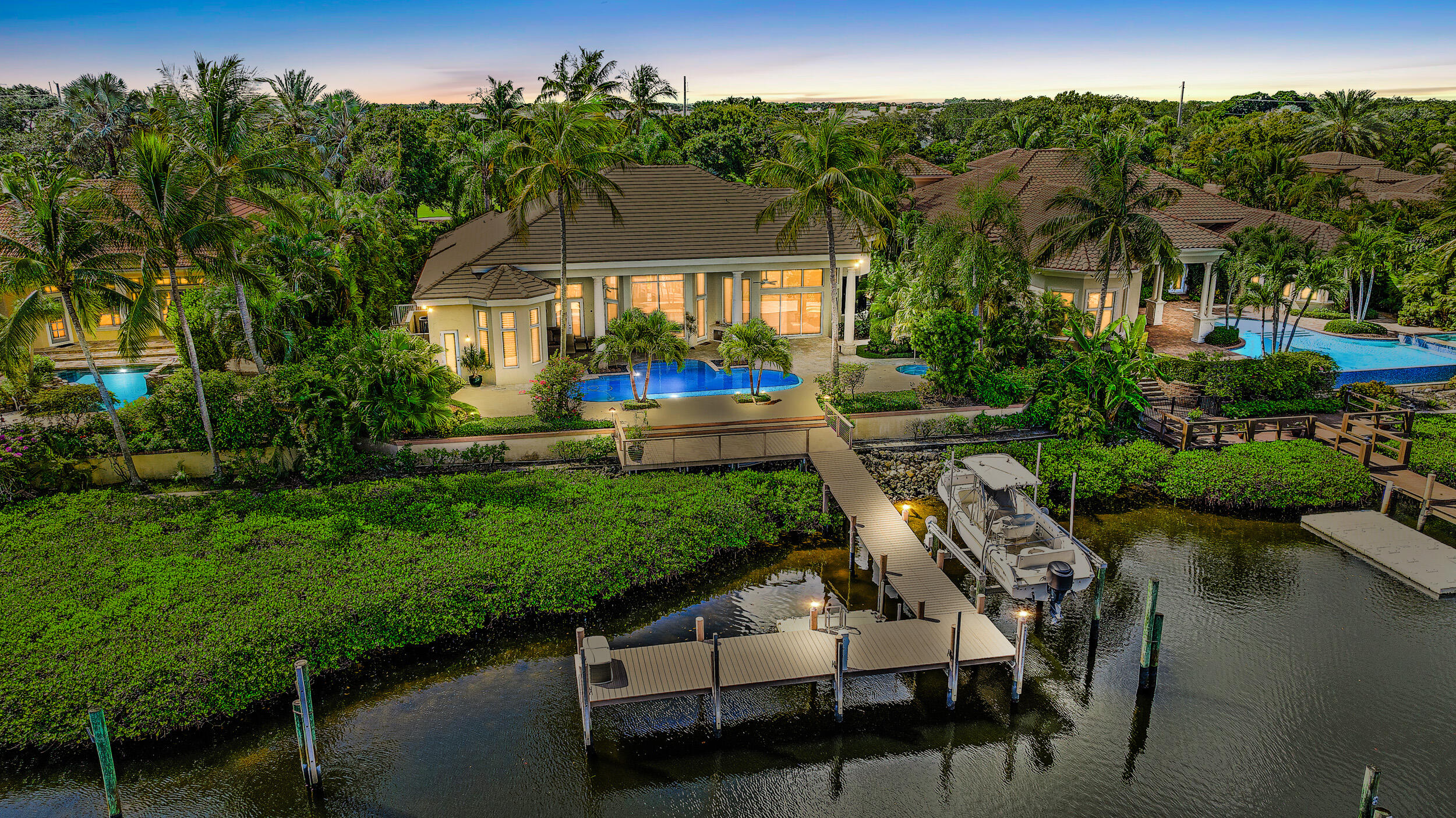 Single Story Waterfront Estate Home - Water in your backyard and golf course in your front yard. This home boasts 4 bedrooms plus an office, 4.2 baths, open kitchen to family room floor plan and tons of outdoor space. Lavish Owner's suite with custom wood flooring, sitting area and fantastic waterviews. 2 large walk-in closets, dual sinks and 2 separate water closets, oversized shower, privacy garden and marble flooring. Outdoor living at its finest with both covered and open air  living space overlooking the pool, spa and interior waterways. Newer roof, pool/patio stone and wood flooring, updated kitchen, large guest suites with private baths, large garage and storage are just a few of this homes many features.