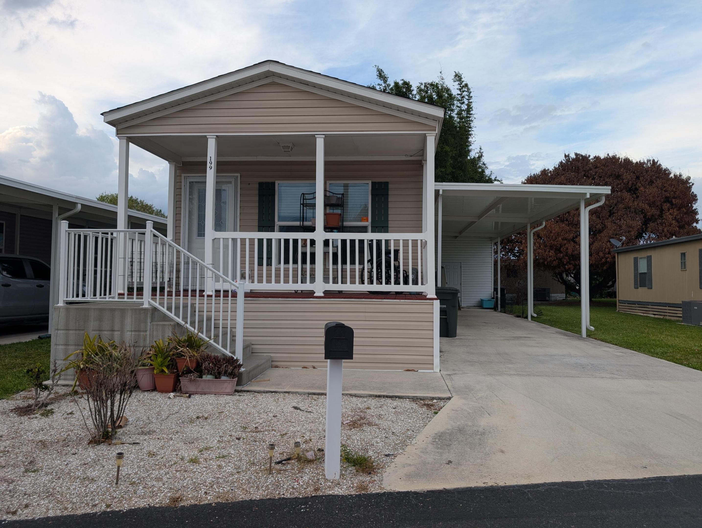 Need to be close to everything? Want a home built in the last decade? Want a social life? Want to move in and relax with everything already done for you? Want it to come with owner financing too? Come see this beautiful home ready for a new owner! Put your beach chair in the shed.  Park your golf cart under roof.  And for lot rent of $810/month you don't even have to mow your own lawn! Sit on  your porch, enjoy the breeze and watch the sunset!