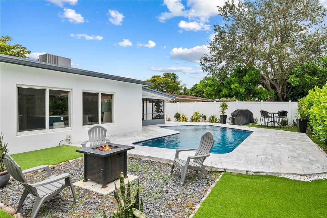 Welcome to your completely renovated, move in ready east Pompano Beach 4 bedroom home! Completely turn-key. Everything from the roof + impact windows, to the interiors, the back yard and the AC, Tankless Water Heater + Electrical have been DONE.  The backyard is a dream with newly installed artificial grass for zero maintenance, new no-slip marble pool deck and refinished oversized pool. Screened in Patio overlooking pool.  Modern/Transitional interiors are perfect for any taste. Corner Lot, 5 minutes to the beach,  15 min to downtown Fort Lauderdale and to Boca. Generates $350-450$/n on vacation rental websites with 80% occupancy