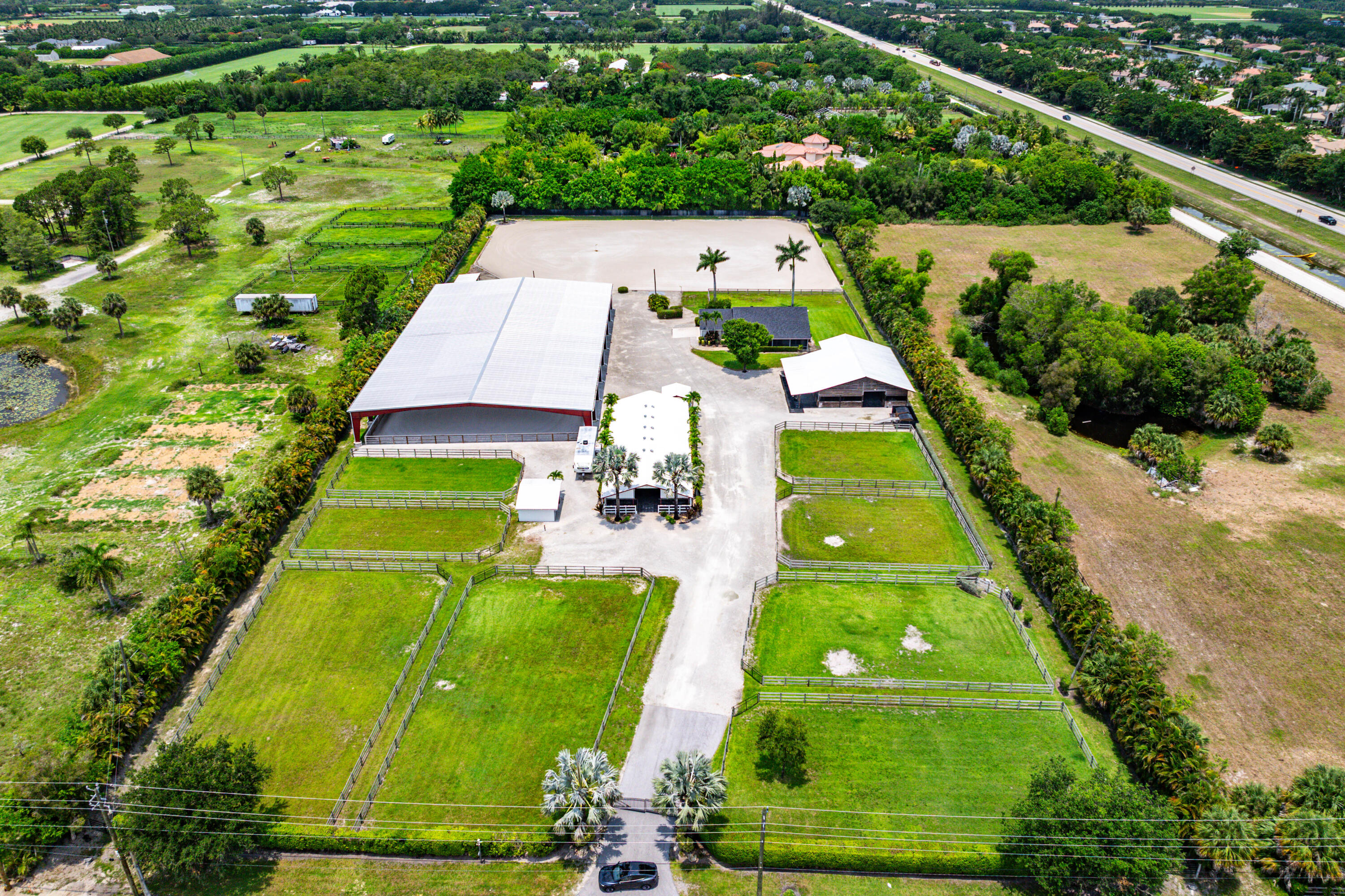 Exceptional turnkey equestrian facility in the heart of Wellington, offering over 5.5 beautifully maintained acres w/newly remodeled home- designed for the serious owner, trainer or investor. This professionally equipped horse farm features 3 barns with a total of 28 stalls and outstanding infrastructure. At the center of the property is a spectacular 110'x200' covered arena w/premium irrigated footing system, providing year round riding regardless of the weather. A large irrigated outdoor sand arena offers additional training space, while 8 irrigated paddocks provide fantastic turnout for horses.The farm is thoughtfully designed w/2 tack rooms, riders lounge & office/apartment. Ready to perform at the highest level whether private training or investment property!               Property Highlights Include:  Prime Wellington location just minutes from all major equestrian venues -   New spectacular 110' x 200' covered irrigated arena  - 3 barns - 28 stalls - Rubber matted aisleway  -  8 irrigated paddocks  -  2 tack rooms-grooming area    Large irrigated outdoor sand arena with covered viewing area - Owner/trainer lounge and office  -  New well and irrigation system -  Wash stalls - 2 separate laundry facilities - Fly control spray system in main barn -  RV hookup  -   Rent out stalls for immediate cash flow.   This is a rare opportunity to acquire a fully operational, turn-key equestrian facility in the equestrian capital of the world!
