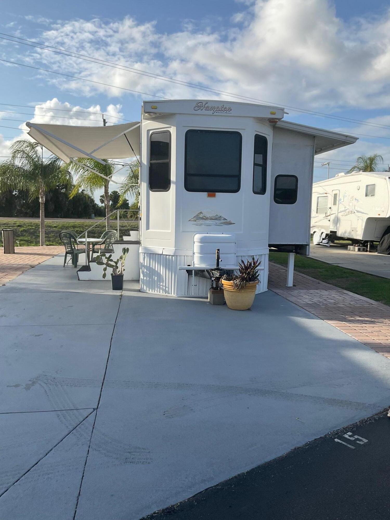 Big O RV Resort- 2011 39' Hampton Travel Trailer, with two slides. Newlyly remodeled bathroom, shower, stackable washer & dryer, ceiling fans, electric fireplace in living room, nicely equipped kitchen, electric awning over patio area, ample parking for your Boat and trailer, and so much more! Located on a deeded lot in Big O RV Resort, a 55+ waterfront community with Lake Okeechobee access. Amenities include heated swimming pool, Clubhouse, community boat ramp, bathhouse, laundry and so much more! Just minutes from Lake Okeechobee, Shopping & dining. Property is being sold furnished Turnkey. Call today