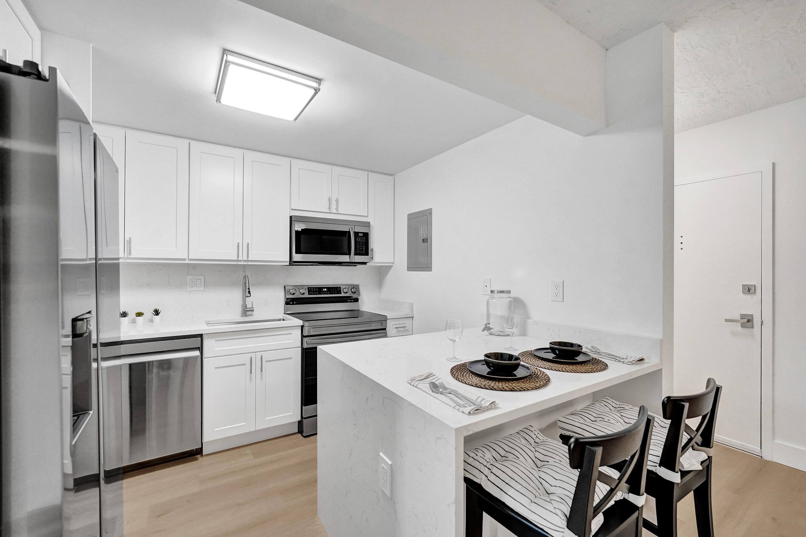 Fully renovated modern 1BR/1.5BA in Omega 4 with EVERYTHING NEW! Highly sought-after quiet 3rd floor north side location. Kitchen features quartz countertops and top-of-the-line Samsung stainless steel, low-profile appliances. Spacious layout with large living area and separate dining. Luxury vinyl flooring throughout. Brand new master bath with floor-to-ceiling porcelain tile and glass-enclosed tub/shower plus updated half bath. Screened balcony with green tree views, new tile, fan and lighting. Brand new central A/C with sleek vents. Ample storage with walk-in closet. 1 assigned parking plus guest parking. Amenities include pool, jacuzzi, tennis court, gym and clubhouse. Pet-friendly. ONLY building allowing immediate rentals (12-month min). Great investment!