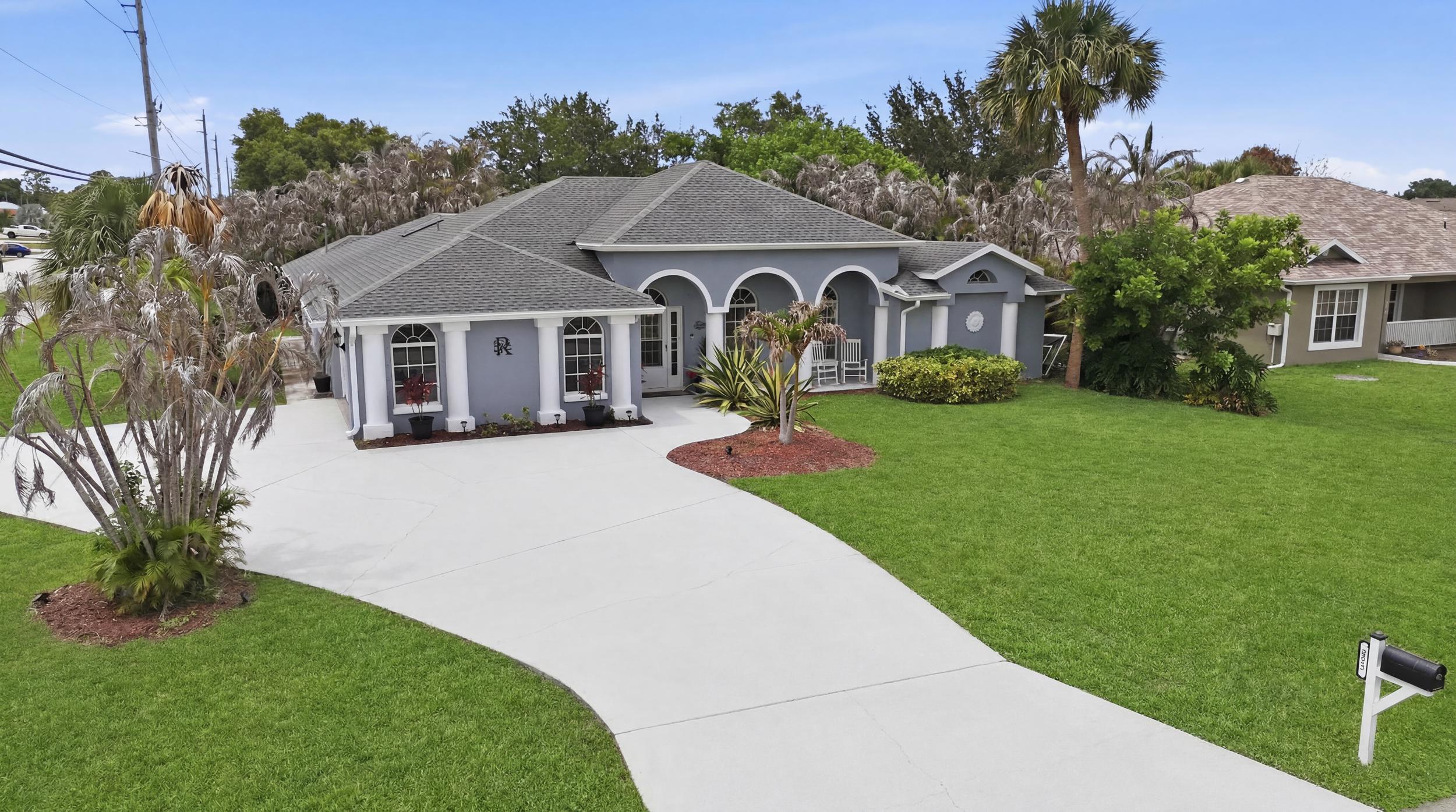 Welcome to this beautifully maintained corner-lot home featuring a spacious circular driveway and exceptional outdoor living. This inviting residence offers a desirable split floor plan, providing privacy and functionality for guests. Inside, you'll find durable tile flooring throughout and a well-appointed kitchen featuring a double oven, perfect for entertaining and everyday convenience. The spacious primary suite includes a relaxing soaking tub in the master bathroom, creating a private retreat within the home. Step outside to enjoy the screened-in pool area, complete with exterior pool lighting that creates the perfect ambiance for evening gatherings. A convenient cabana bath provides easy access from the pool area, enhancing the home's indoor-outdoor lifestyle.