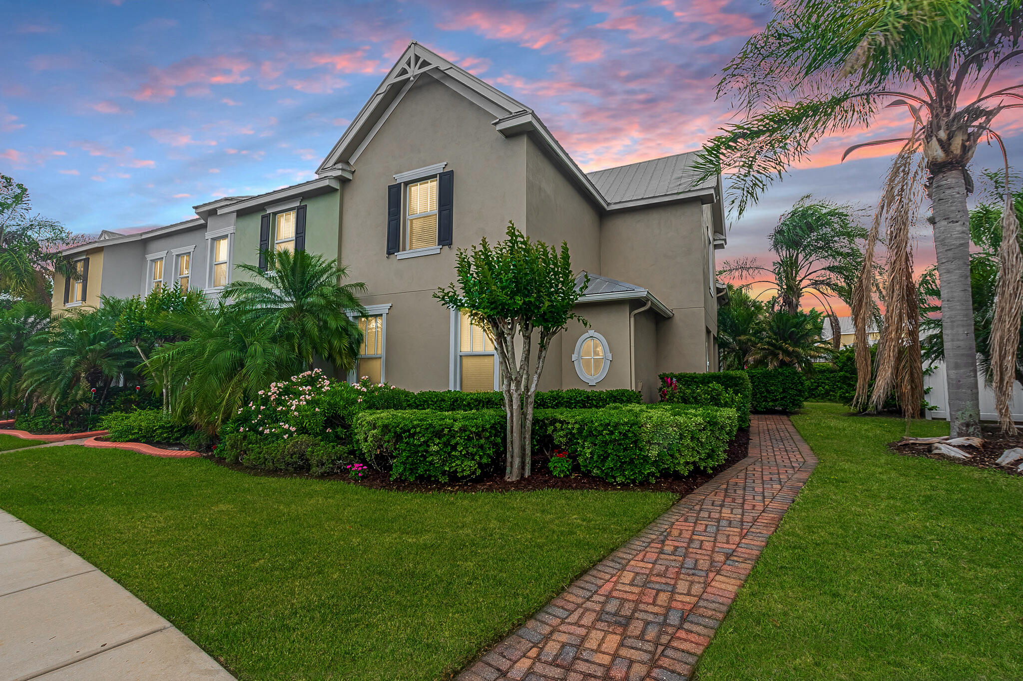 Discover effortless living in Bedford Park with this beautifully upgraded 3BR/2.5BA CBS corner townhome offering privacy & style. Lush landscaping & 6-ft hedges create a serene setting, while inside you'll find 20x20 tile, plush carpet, impact window & a bright, open layout. The modern kitchen features luxury grade quartzite countertops, 42" cabinetry & stainless appliances. Enjoy the convenience of a first-floor primary suite & laundry, plus a versatile upstairs loft—perfect for a home office or flex space. New A/C (2025) adds peace of mind. Across from the community pool & a block to Butterfly Park. Walk to Tradition Square dining, shopping & more. Near I-95—HOA covers cable, internet, lawn care, exterior maintenance & Pest control. Schedule your showing today!