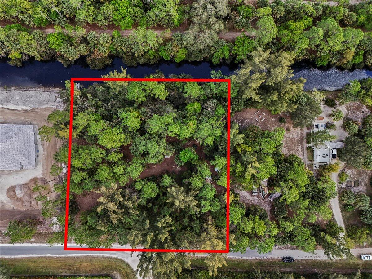 Rare opportunity to own 1.15 acres in the heart of Jupiter Farms with direct frontage on the scenic Loxahatchee River, directly across from Riverbend Park. One of the few remaining buildable waterfront lots in the area, this private property offers the ultimate Florida lifestyle.

Launch your boat or kayak from your backyard and cruise across to Riverbend Park's miles of trails and natural beauty. Enjoy encounters with native wildlife including manatees, alligators, snook and tarpon. Tucked off paved roads for added privacy, yet conveniently located within Jupiter Farms, this property offers the perfect blend of seclusion and accessibility.

Build your dream estate surrounded by nature, water and tranquility — a true Old Florida setting that's becoming increasingly rare.
