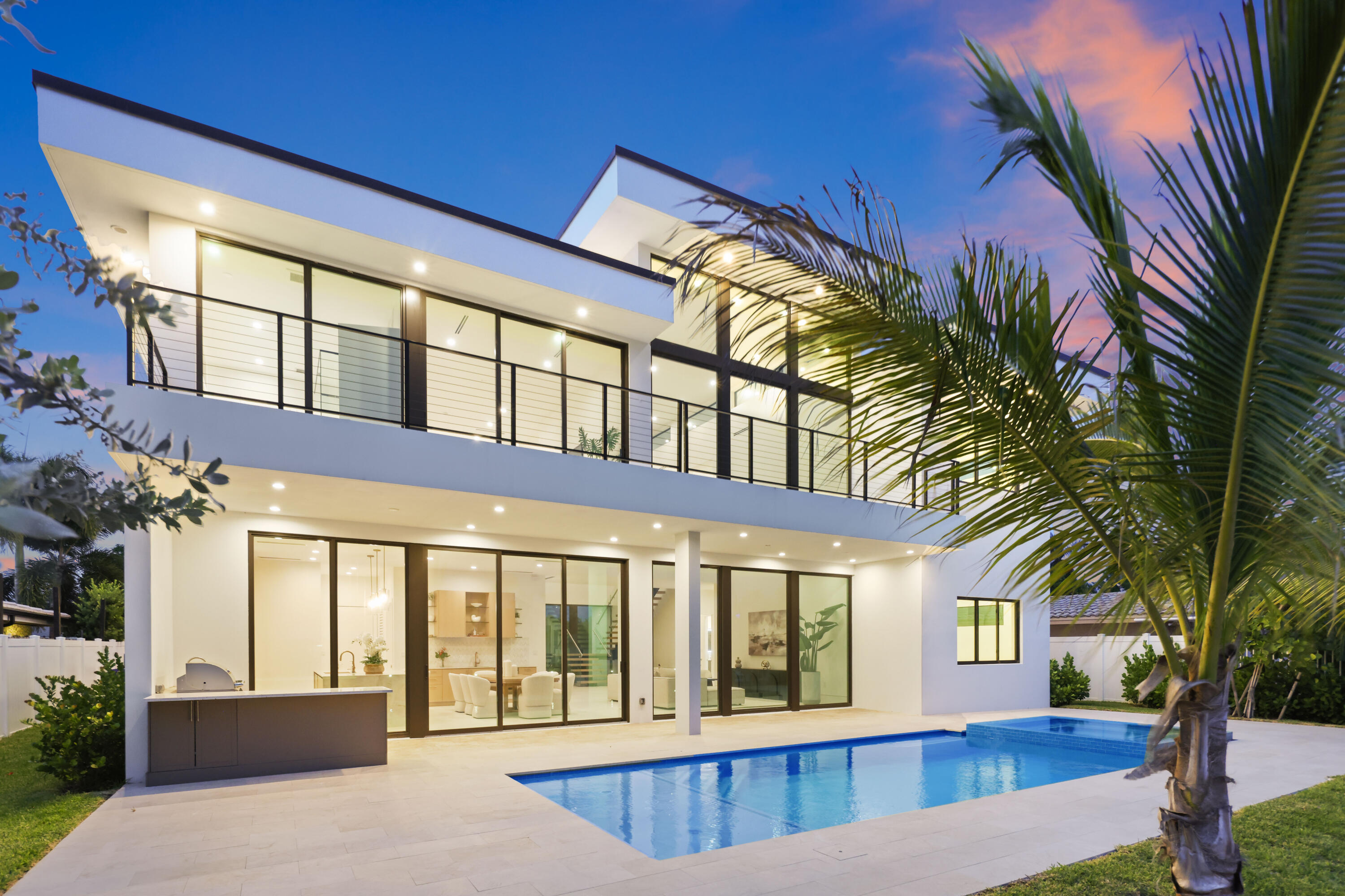 Brand-new modern waterfront estate offering the ultimate South Florida lifestyle. This exceptional 2-story residence features floor-to-ceiling glass, a stunning steel/wood/glass floating staircase, 4x4 porcelain flooring, and breathtaking water views from nearly every room. The chef's kitchen showcases Sub-Zero and Wolf appliances, matte-gold fixtures, a 5x10 island, and a custom wet bar. The 5BR/5BA home includes a luxurious owner's suite with dual balconies, spa-inspired bath, designer walk-in closet, and serene waterfront views. Enjoy resort-style outdoor living with a 17x32 pool, spa, lush tropical landscaping, privacy fencing, full summer kitchen, and a new 75' dock currently accommodating a 62' Azimut yacht. A refined waterfront masterpiece ready for its next owner.