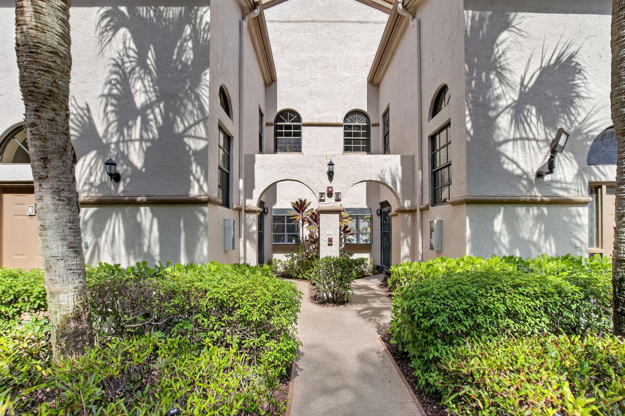 Welcome to this spacious 1st floor 2-bedroom, 2-bath condo with a versatile den that can easily serve as a third bedroom. Tucked away in a quiet location surrounded by green space, this home offers a functional split-bedroom floor plan and is priced to reflect the opportunity for a buyer to update it to their own taste. The layout features low-maintenance tile throughout the main living areas and second bedroom, with wood-look laminate flooring in the primary bedroom. The eat-in kitchen offers generous cabinet storage and a large pantry, while the glass- and screen-enclosed patio provides a comfortable place to relax and enjoy the peaceful outdoor setting. A private storage closet just outside the entry door adds everyday convenience, and the hot water heater was replaced in July 2024.  Virtual staging has been used in the photos to help illustrate the possibilities this well-priced home has to offer.    Discerning buyers place PLATINA at the TOP OF THEIR LIST! The community offers care-free, resort-style living at its very best! AT&T FIBER OPTIC HIGH SPEED INTERNET is INCLUDED IN THE CONDO FEES along with PEST CONTROL, ROOF MAINTENANCE and WATER. All you pay for is electricity! Cafe open for breakfast and lunch offering take-out meals, card rooms, fitness center with stationary bicycles in a solarium overlooking the pool area. Relax in one of the satellite pools or at the enormous free-form main pool and spacious sundeck. Tennis, handball and pickleball courts. There is also an art room with a kiln! With shows, bingo, and an array of clubs, you will not be bored! 24-hour guard gated community. Convenient access to I-95 and the Florida Turnpike. Close to shopping and wonderful restaurants. NOTE: The clubhouse will be closing soon for complete renovation.