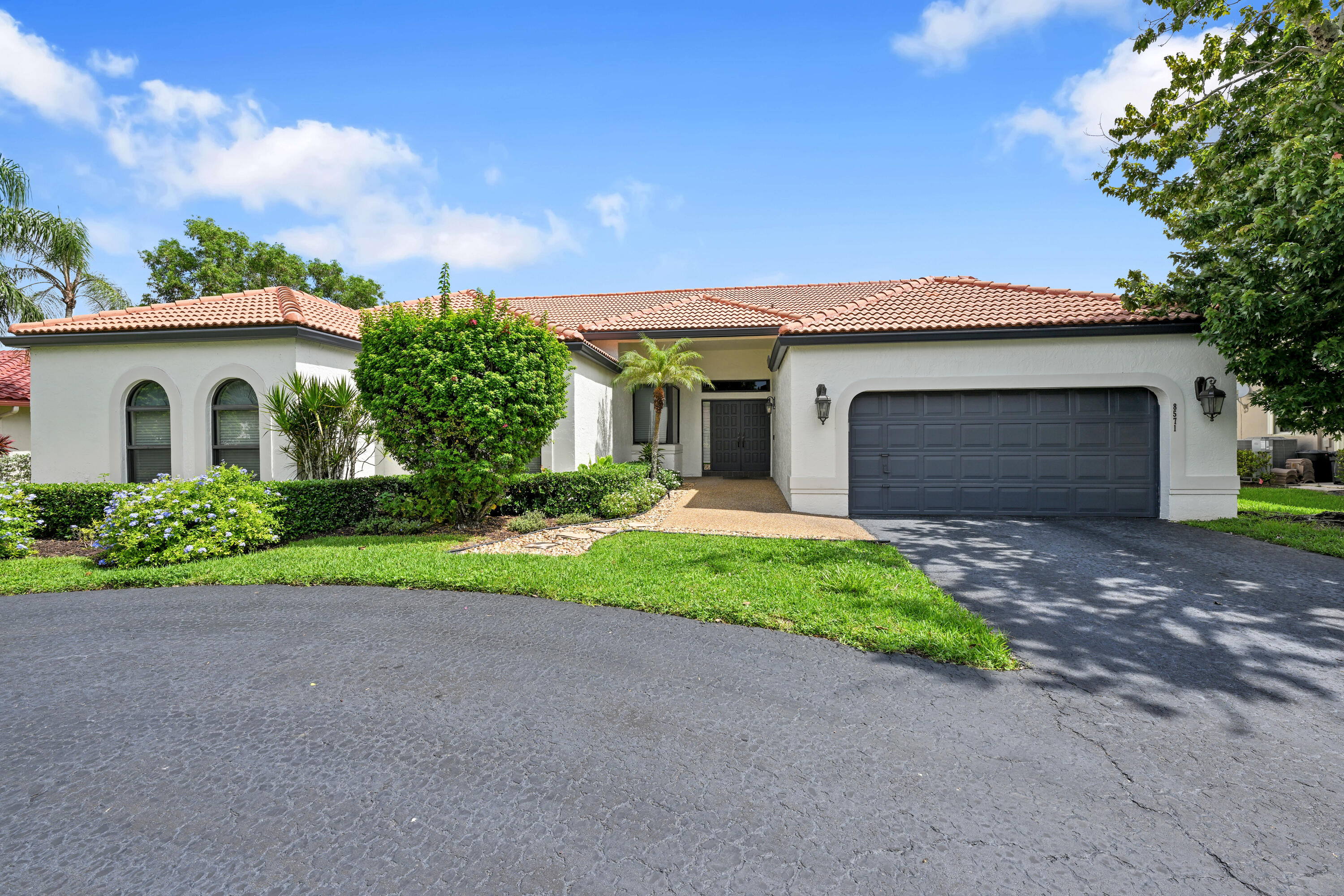 Experience beautiful South Florida living in this impeccably updated waterfront pool home in the desirable Pine Ridge community offering 4 bedrooms and 3 1/2 baths. Perfect for entertaining from the oversized kitchen with convection oven and conduction cooktop. The  kitchen has a huge island with seating and  offers a ton of storage.  This home features a great open split floor plan with lots of natural lighting, and large bedrooms. The bathrooms offer luxury modern finishings.  Then step outside to relax in your screened in patio, with a fenced yard and salt water pool overlooking the canal. Partial impact windows. 2026 pool pump & 2025 filter housing. 3 baths have new Toto toilets 2025. Low HOA, excellent schools and parks, lots of dining and easy access to expressways. Dining Room and Primary Bath Chandelier do no convey.