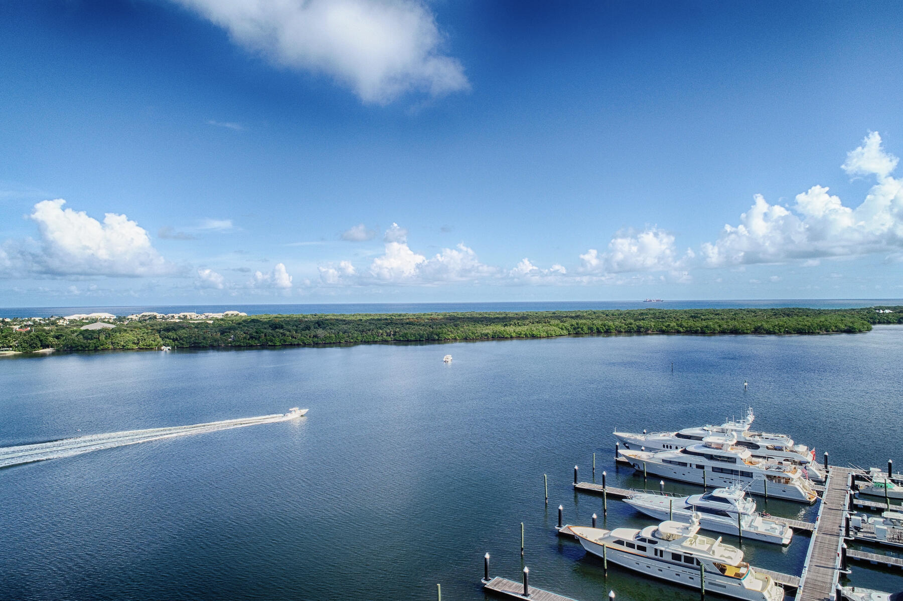 Wake up to beautiful views of the Intracoastal, Old Port Cove Marina, and the Atlantic Ocean from every room of this updated 2-bedroom, 2.5-bathroom condo. Located on the 7th floor, this residence offers a luxurious coastal lifestyle in one of the area's premiere gated communities. Step into a grand foyer that opens to a spacious living area, perfect for entertaining, complete with a built-in bar and floor-to-ceiling windows that showcase the stunning water views. The updated kitchen features sleek stainless steel appliances, modern cabinetry, and ample counter space. Retreat to the remodeled master suite, featuring 2 walk-in closets, an oversized walk-in shower with a bench, dual vanities, and a private water closet. The guest suite is equally inviting with its own walk-in closet with built-ins and a private ensuite bath with a walk-in shower. Enjoy this secure, full-service building offering 24-hour concierge, on-site management, new heated pool, spa, summer bb1, new fitness center, and more. Located just minutes from world-class shopping, dining, golf, and miles of pristine coastline. Garage Parking #52 and Storage Cage #23.  All inspections are complete, Lobby, social room, hallways and motor lobby are under construction and will be paid for by the current owners.  Renderings are uploaded.