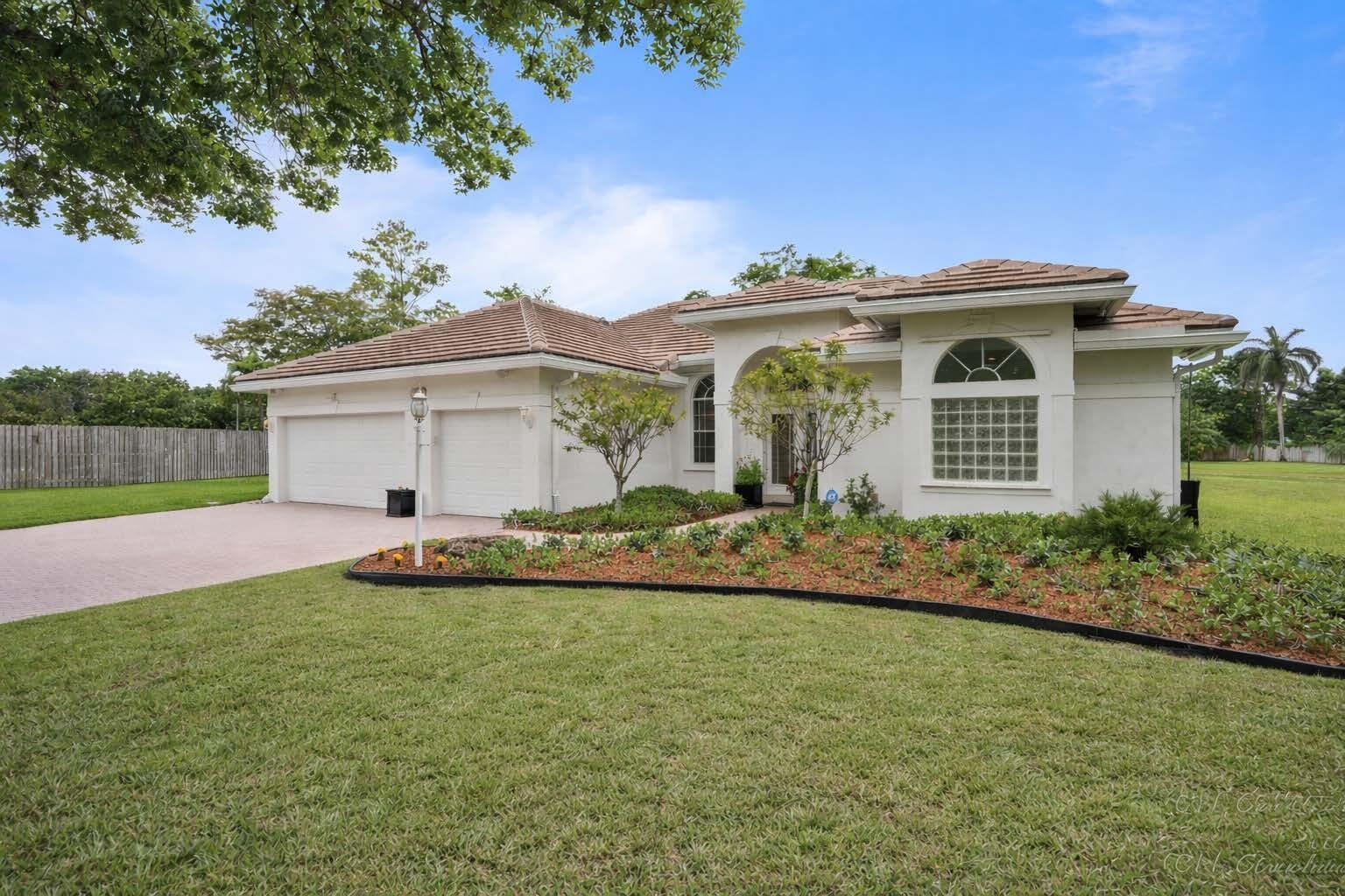 Rare opportunity in gated Estates of Stirling Lake. One of the largest premium 1/2+ acre cul-de-sac lots with serene lakefront views and ultimate privacy with no rear neighbors. This impeccably maintained triple-split plan features remodeled baths, custom pantry, laundry room and a large kitchen and expanded family room overlooking the oversized screened patio, pool, and expansive lakefront yard with room to expand. Features include a 2023 roof and gutters, newer 16 SEER Rheem A/C, hurricane-rated insulated garage doors, and lake-fed irrigation. Walk to the top-rated elementary school just down the street. Prime West Davie location close to shopping, dining and easy highway access. Low HOA includes playground and tennis. This is truly one of the most special lots in the community.