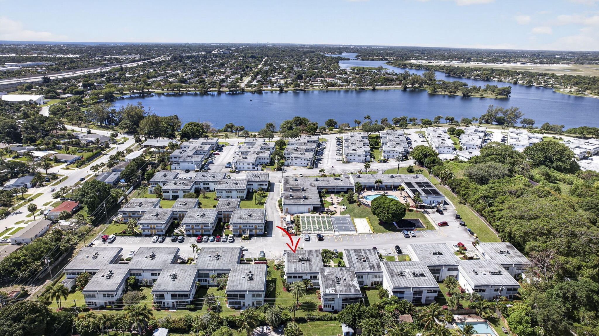 Location, location, location! Close 2 beach, 95, Tri-Rail, WPB, Delray Beach! This is a jewel of a unit. Move-in ready! 2 bedrms/1 bath. Large WIC. Gorgeous tile floors mimicking travertine. High-end renovation in kitchen w/premium cabinets & granite countertops. Lots of natural light because it's an end unit w/4 extra windows on East side of unit. NEW windows throughout including balcony overlooking pretty green space. New AC. Bldg 23 sits behind recreation area w/large pool, pickleball/shuffleboard/bocce ball courts, putting green, BBQ area, auditorium, craft room, library, 2 gyms, saunas, etc. This bldg sits on small hill providing views over neighboring buildings. Unit location in community provides tremendous privacy compared to other units. Tinted windows help lower utility costs. Well-managed 55+ development across from 750-acre John Prince Park and Lake Osborne. No pets. 700+ credit score required.