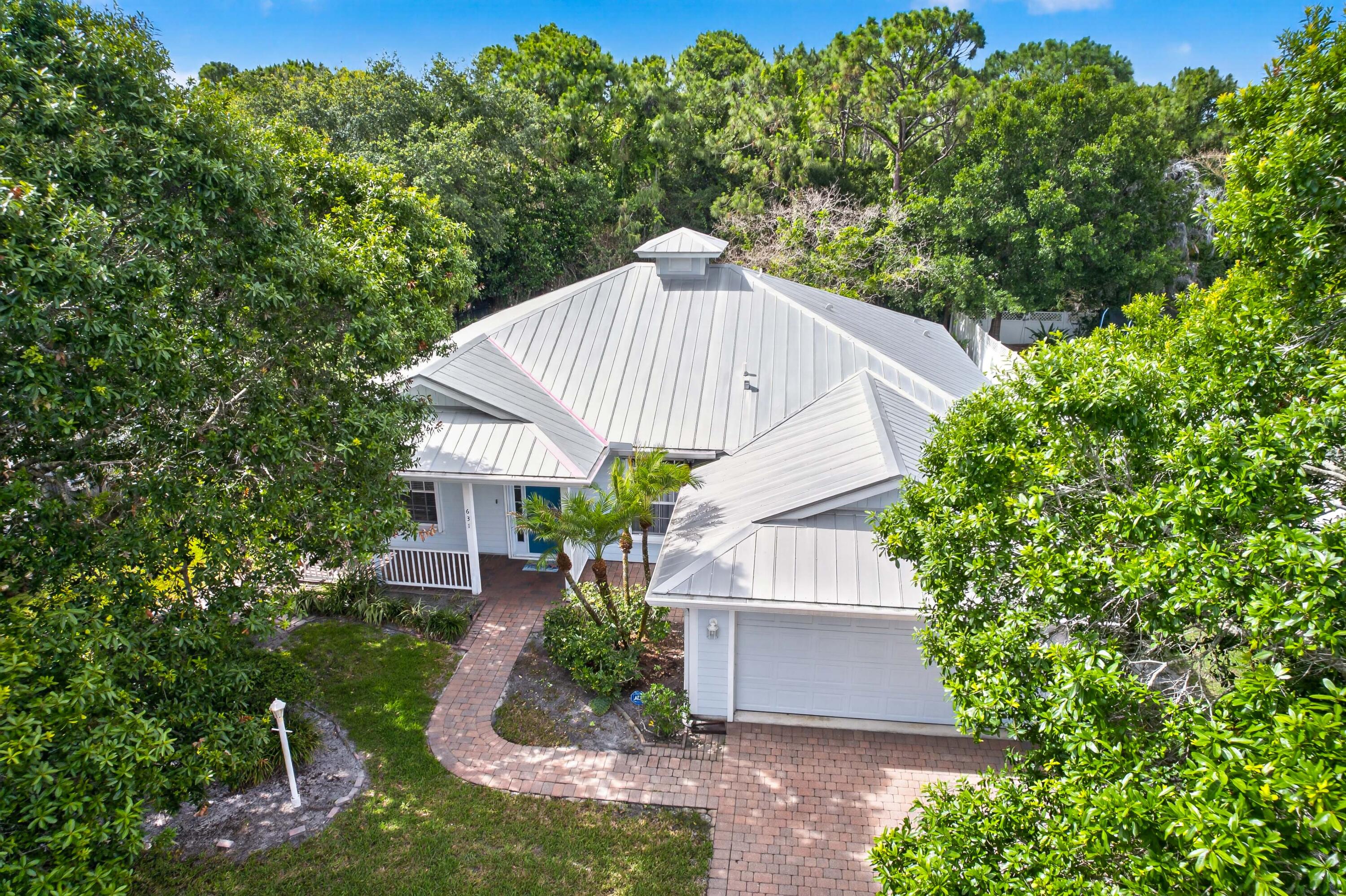 Spacious 3BR/2BA Key West style home featuring the larger 1806 s/f floor plan in Little Kayak Point at River Place on the Saint Lucie. The inviting eat-in kitchen serves as the heart of the home while the welcoming front porch, covered back patio and oversized backyard provide plenty of space to relax and entertain outdoors.  Built with sturdy concrete block  construction, metal roof and hurricane shutters for added peace of mind. Resort style amenities including a community pool, hot tub,  fitness center, canoe/kayak launch, boat/RV storage, playground, park and scenic nature trails.  Experience the epitome of Florida living! Great location just minutes from shopping, dining and major roadways.