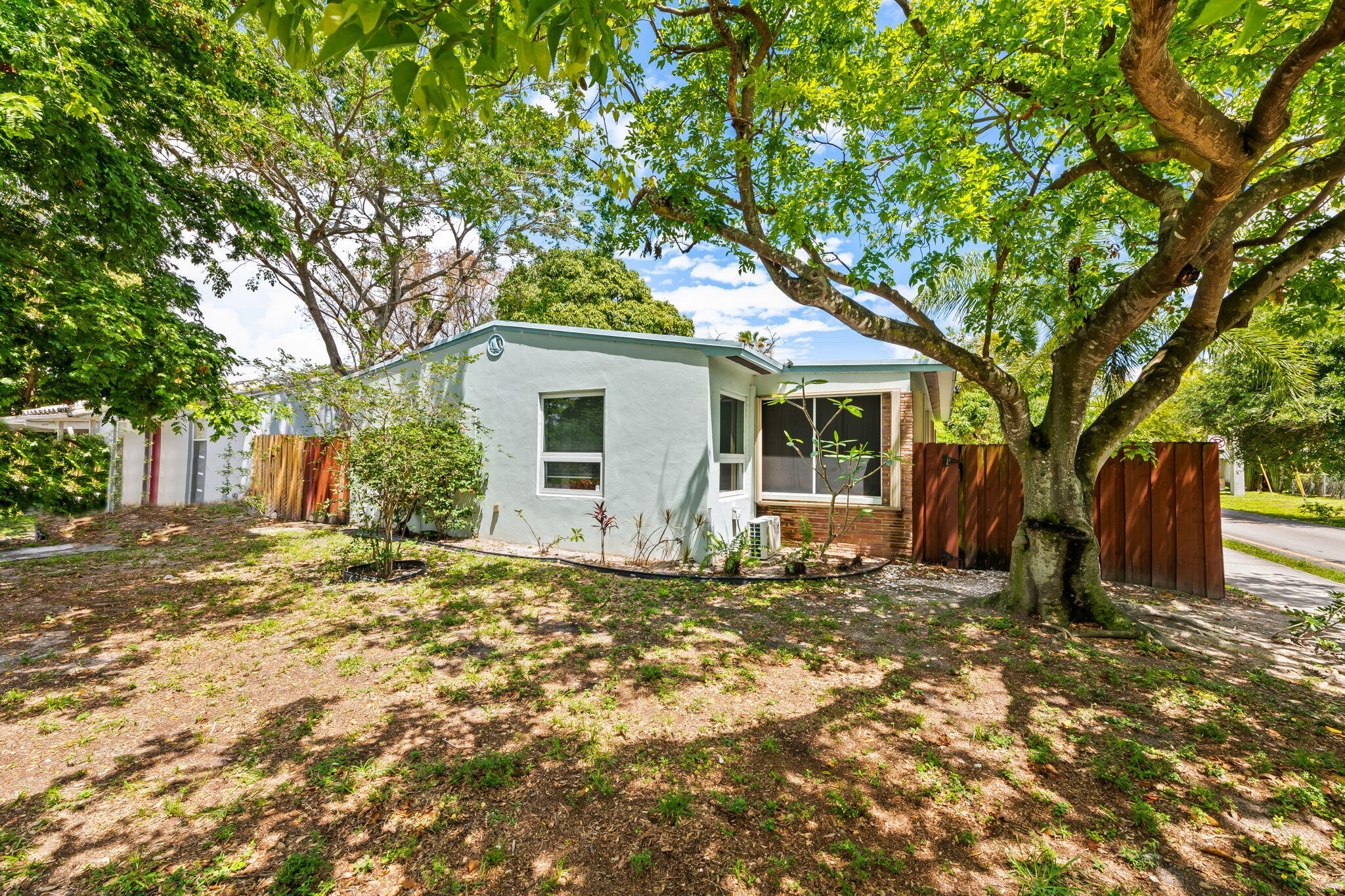 Discover the perfect blend of mid-century charm and modern updates with this income-generating duplex in the South Middle River community. Situated on a spacious corner lot, this property is a standout opportunity for savvy investors or an owner-occupant looking to live in one unit while offsetting their mortgage with rental income. This maintained duplex features two spacious 1-bedroom, 1-bathroom units, each offering: full impact windows and doors throughout, each unit boasts tile flooring, both units feature their own private, screened-in porch, perfect for enjoying the South Florida breeze, a fully fenced backyard with lush tropical landscaping offers a serene garden retreat for tenants, an on-site shared laundry facility and ample off-street parking for up to 4 vehicles.