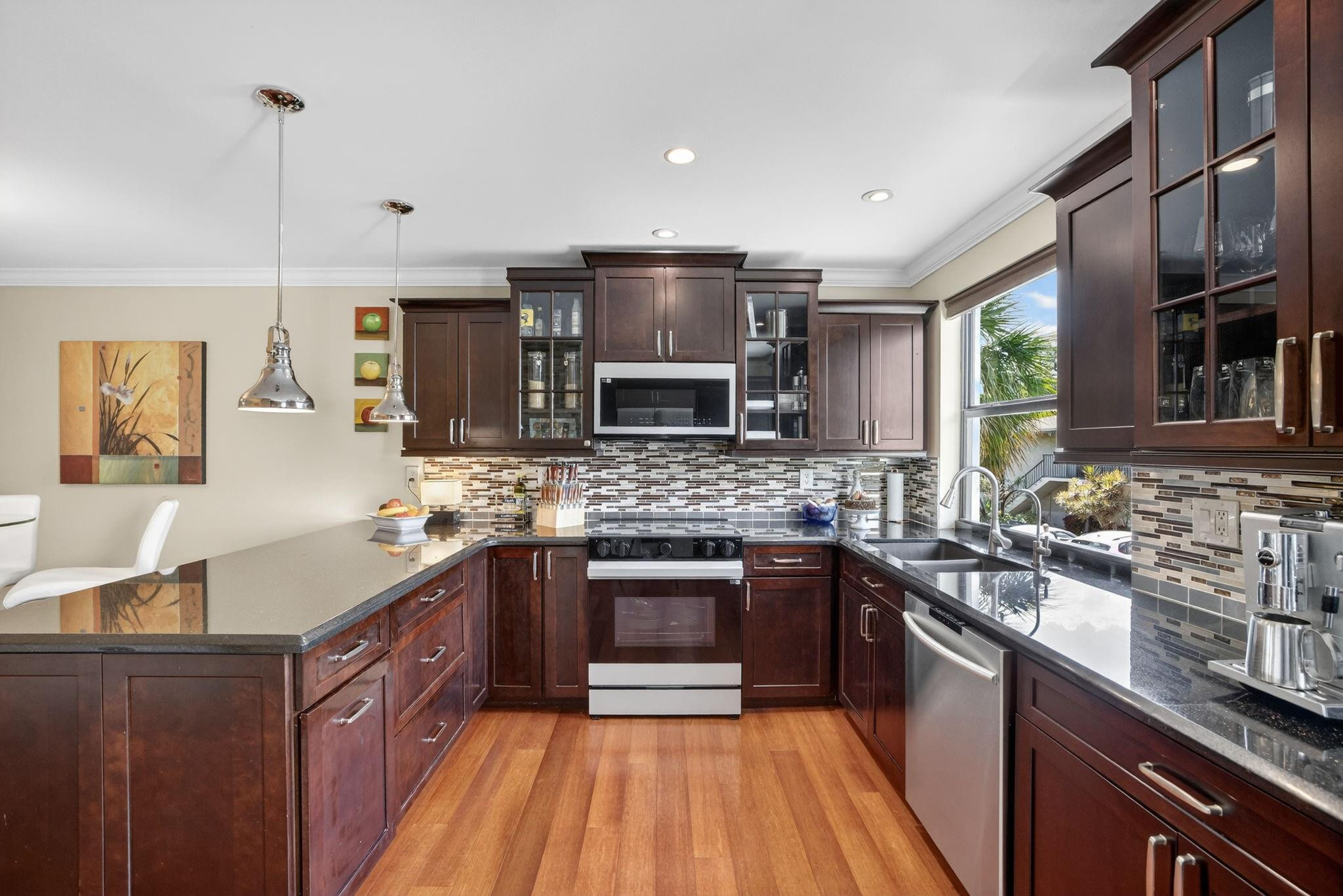 Live and entertain vibrantly in this rare 4-story fee-simple townhome in the heart of Wilton Manors! With electric nightlife just steps from Wilton Drive bars, clubs, and events, this upgraded 3-bed/2.5-bath home delivers over 2,146 sq ft of pure lifestyle. Soaring 13-ft ceilings, stunning hardwood floors, brand-new appliances, an open-concept loft, private fenced yard, and modern flair throughout create a space that feels alive the moment you walk in. Enjoy a brand-new higher-end Square D electrical panel (2026), recently sealed roof, high-efficiency hurricane-impact windows and doors, and a spacious oversized 1-car garage that stands out from the rest. With a super-low $167/month HOA and true fee-simple ownership, this is your stylish, low-maintenance smart buy with real ownership peace  This is a true fee-simple townhome — you own the structure and the land beneath it. Low $167/month HOA covers only neighborhood roads and common areas. Exempt from Florida's new Structural Integrity Reserve laws that are driving massive special assessments in many condominiums. True livable square footage is 2,146 sq ft (per complex plans and laser measurements). Newer appliances, recently sealed roof, and brand-new 2026 electrical panel. Hurricane-impact windows and doors throughout. Private fenced yard and oversized 1-car garage.