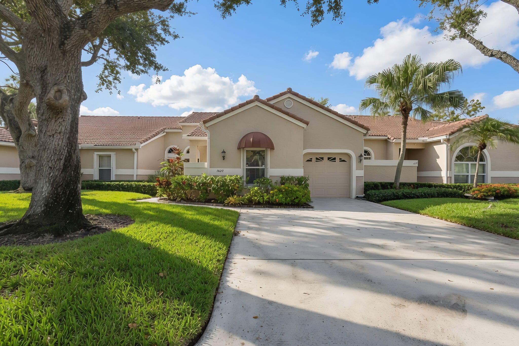 Thoughtfully renovated in 2021, this light-filled 2-bedroom, 2-bath single-story villa with a 1-car garage is located in the desirable Heather Run community of PGA National. The split-bedroom floor plan features vaulted ceilings, skylights, and an open great room with a three-panel sliding glass door leading to an enclosed Florida room overlooking a private, landscaped backyard, adding valuable living space. Competitively priced, the home offers an excellent opportunity for the next owner to personalize it to their own style. The garage includes a large ceiling-mounted metal storage rack for exceptional overhead storage. Low HOA fees cover exterior painting and roof maintenance, repair, and replacement, and the community pool is conveniently located just across the street. Owners may lease the property up to two times per year with a 90-day minimum lease term.  Known for its championship golf and resort-style setting, PGA National is one of Palm Beach Gardens' premier golf communities. Optional memberships to the PGA National Members Club offer Golf, Sports, and Racquet options. Ideally located near Interstate 95, the Florida Turnpike, exceptional shopping, dining, and area beaches.