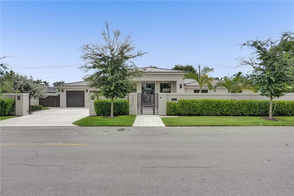 Gorgeous gated remodeled home in the private Coral Ridge Country Club community. This hard to find rare gem boasts 5 bedrooms & 4 1/2 baths, perfect for the growing family. Great room design has 13' ceilings, beautiful large wood plank floors throughout  the home. Exquisite chefs kitchen includes Six Burner Gas Range,  Stainless Steel Side by Side Refrigerator, Wine Cooler, Microwave, Dishwasher and Wall Oven. Stunning "leathered granite" on the countertops, handsome custom cabinetry, island entertaining area. A Privacy wall surrounds the home. Oversized lot with heated, saltwater pool/spa for relaxing.  Extras include water filtration system, 48K generator, insta-hot water system,  EV charging station. Note: House built 1965--major remodeling done 2018.