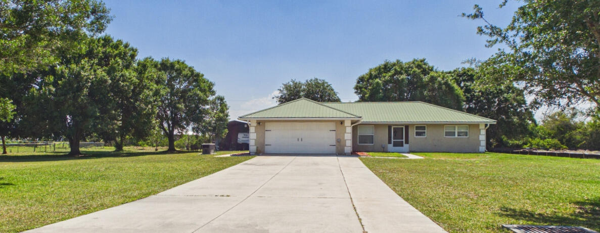 Welcome to your own slice of Okeechobee living, where comfort, space, and functionality come together. This solid CBS home features a newer metal roof and an incredible enclosed porch, a light filled space that extends your living area and is perfect for relaxing or entertaining year round. Inside, the home offers a true turn-key feel with a spacious primary suite, open living areas, and a desirable split floor plan. Thoughtful updates include brand new appliances, a new water heater, and newer AC. Both bathrooms have been newly remodeled with everything updated. Outside offers a large workshop, additional shed, and fire pit area, plus plenty of room for parking boats/RVs/toys. A whole house generator adds convenience and peace of mind. This is a must-see for yourself!