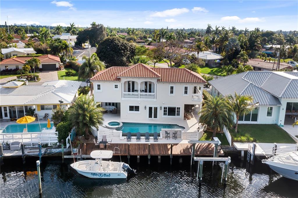 This Amazing Coastal Home is located on the King Fisher Canal in the Cove.  The home features 5 bedrooms and 5 full bathrooms.  The Open Concept Eat In Kitchen has a huge Quartzite Island, Wolf Stove, Subzero Fridge, and 2 Dishwashers. The Large Master Suite is truly fit for a King or Queen with breathtaking water views! AN ENORMOUS WALK IN CLOSET, Beautiful On Suite Bathroom with free standing tub. The location on the property is on the wide basin of the King Fisher Canal so bring your boat or yacht!  2 covered patios, tropical pool and beautiful palm trees make this a true Coastal Retreat to enjoy everyday of the year.