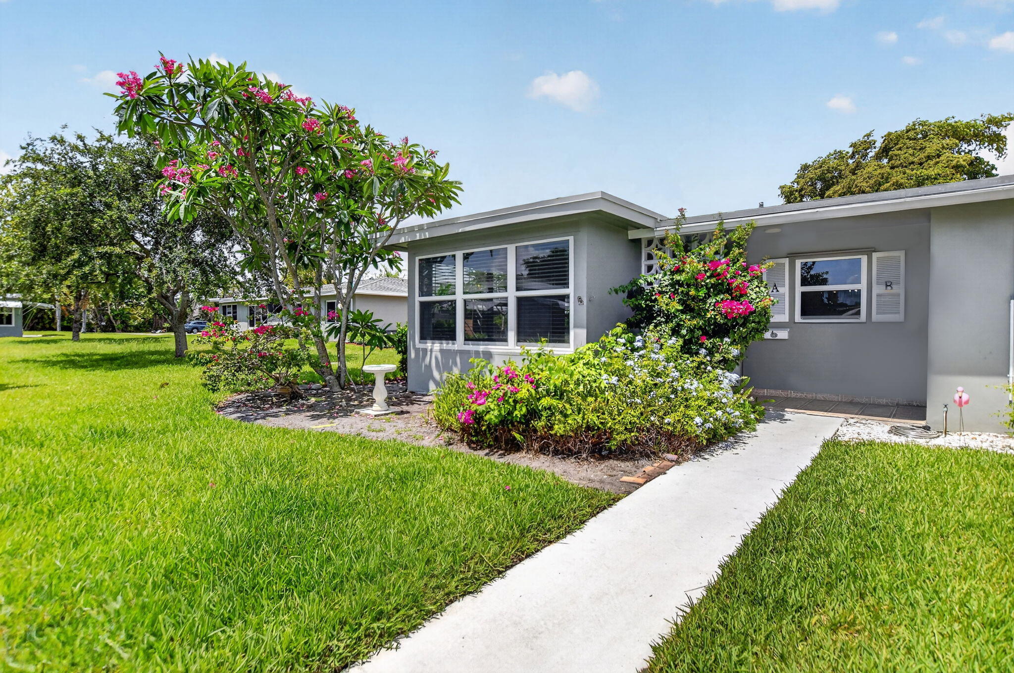 Welcome home to High Point Sec III, an active, idyllic 55+ Delray Beach community. Perfectly located just steps from the clubhouse and amenities, this light-filled 2BD/2BA corner villa features a sunny kitchen with pantry storage and updated appliances. Highlights include complete impact windows and impact patio door, oversized 10x20 open-air patio surrounded by lush greenery, neutral tile flooring throughout, spacious living and dining areas, sunny Florida room ideal as a den or office, new A/C (2023), new electrical panel (2026), new water heater (2026), pull-down attic storage, and exterior awnings. Enjoy the pool, bocce, billiards, BBQ area, plus cable and internet included in monthly dues. Minutes to downtown's Atlantic Ave dining, shopping, entertainment, and beautiful beaches!