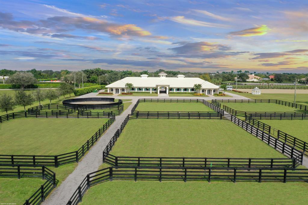 Unparalleled Location! Prime 10.63 Acre equestrian estate with direct bridle path access & within true hacking distance to WEF. 6Br/7Bth pool home with top quality detail & finishes. 14 stall center-aisle stable with all the amenities including:  two studio apartments, one 1BR/1BA manager's apartment and a rider's lounge with kitchenette. The property also boasts a large riding arena, grand prix grass riding field, round pen & 10 grass paddocks. The main residence is beautifully appointed with center-island kitchen with French range with gas & electric ovens, wine chiller & subzero refrigerator, and beautiful handcrafted wood built-ins in the family room & office. This property has been meticulously designed & maintained! A great value close to Grand Prix Village & the WEF Showgrounds!