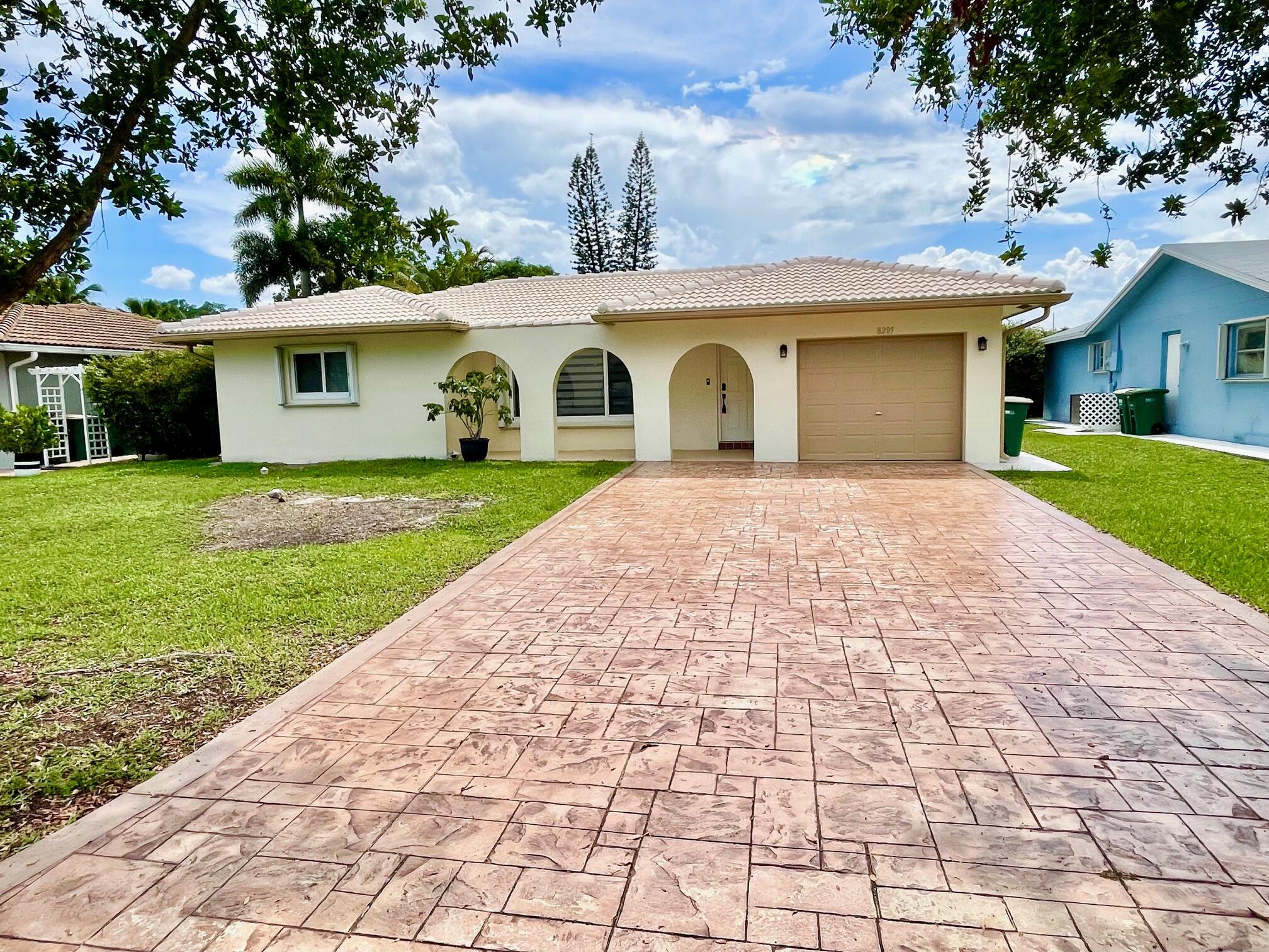 Exquisitely renovated residence has 2-3 bedrooms, 2-baths, Attached 1 Car Garage,  offered for rent. Currently setup with 2 Bedrooms w/extra room in back for home office/nursery/3rd Bedroom.  This sophisticated, "move-in"-ready home showcases a designer kitchen w/quartz Counters w/newer stainless appliances, elegantly updated bathrooms, new flooring and modern lighting throughout, hurricane shutters on windows and doors.  Ideally situated in a prime location with easy access to shopping, dining, and major thoroughfares. Impeccably upgraded with refined finishes—this exceptional home is a rare rental opportunity. Incl. Comm. PooL - Small Pet Okay w/$250 Non Refundable Deposit. Owner cuts Grass - Tenants pay Utilities. 650 Min Credit. 1st Mo, Last Mo, One Mo Security Deposit. Call Today!