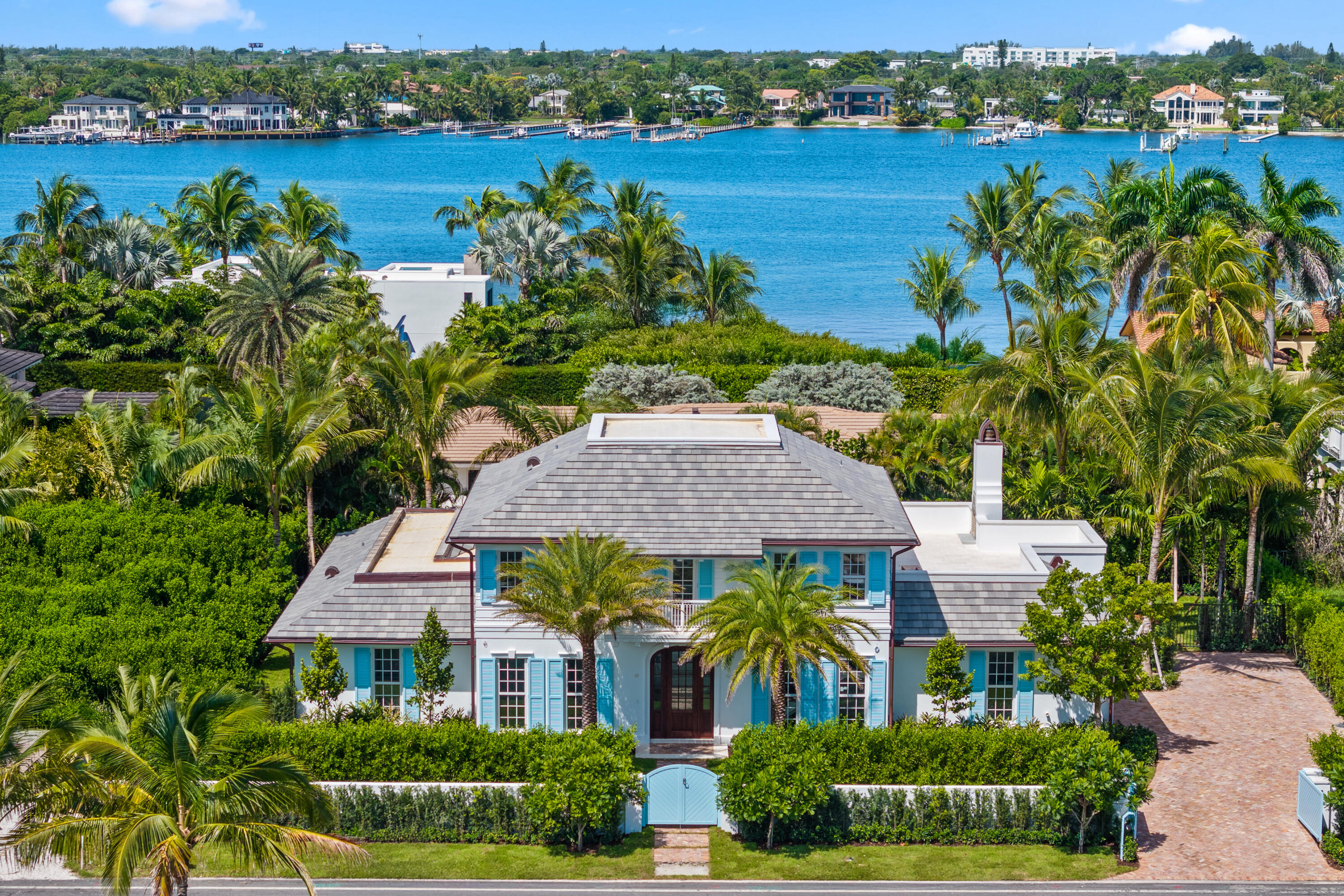 JUST COMPLETED - BRAND NEW CONSTRUCTION 2025! Set on the private shores of Palm Beach's Ibis Isle, this elegant designer residence defines seamless indoor-outdoor living. The gracious 12,314 SF property is wrapped in lush landscaping & offers 5 bedrooms & 5.1 bathrooms, a first-floor primary suite with vaulted ceilings & a Calacatta marble spa-inspired bath. Oak flooring runs through the main living areas & is complemented by high ceilings & top-tier finishes. The open kitchen showcases a custom Officine Gullo range, Miele appliances, and marble countertops. Upstairs, 3 ensuite bedrooms & a loft that opens to a spacious rooftop terrace with a wood-burning fireplace. Outdoor spaces feature a heated pool, summer kitchen, two-car garage & elevator ready. Exclusive, secure, & just steps from the beachthis home captures the essence of Palm Beach living.