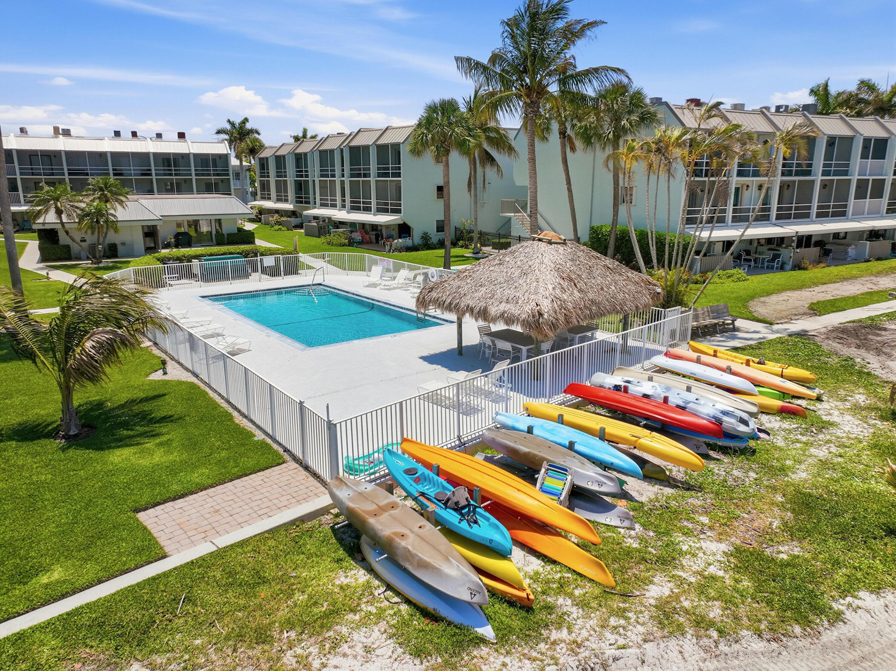 Positively Paradise! Rarely offered Straight Away Water View 1st Floor furnished unit at La Entrada Del Mar.  Enjoy this charming 2/2 with it's open kitchen with jaw dropping views, no stairs and super convenient parking. This well-loved seaside community is comprised of 57 units and feels like an island retreat because it truly is. A new 40 slip Marina is being constructed and is slated for completion Fall 2026. Enjoy the thrills of water views and ships passing by from your premier bedroom, living room and 25 x 9 Sweeping covered patio. She's spruced up and ready to go with new microwave, and all the furniture too. The masterfully located heated pool with tiki is just steps from their nearly 300 ft of inlet beach frontage and under construction, "brand new marina." There will be 30 owned docks with lifts and 10 in common docks owned by the residents only. The Assessment is paid! LEDM has a central community center where a variety of fun gatherings are hosted.  This premier location is nestled in the center of all the restaurants and very close to the Jetty. If you desire a tranquil community, yet be close to all of the daily hot local spots dotted along the intercoastal waterway from the Seaway Bridge to the Famous Fort Pierce Jetty look no further and come tour this beauty. Hutchinson Island boasts 23 miles of glorious and free parking beaches; we have Horseback riding 8 miles away, a Bonafide dog beach, and our Naturist beach which has just gone through fantastic upgrades. It is 1 of 3 Naturist beaches in the state.  Relax and enjoy every moment in your personal retreat.