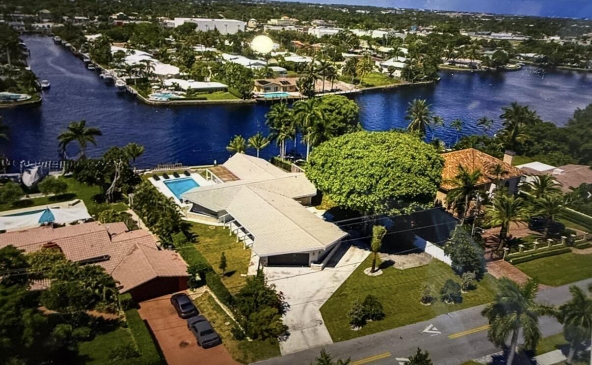 Situated Along the Middle River in the Highly Desirable Coral Ridge Neighborhood, this Exceptional Mid-Century Modern Residence is a True Architectural Gem. Originally Designed in 1960 by Acclaimed Architects Dan Duckham and Chester Trowbridge, the Home Underwent a Meticulous, Down-To-The-Studs Restoration in 2018, Thoughtfully Preserving its Design Heritage While Incorporating Modern Comforts. Inspired by the Principles of Frank Lloyd Wright, the Single-Story Residence Showcases an Iconic Asymmetrical Roofline, Expansive Walls of Glass, and a Seamless Integration of Indoor and Outdoor Living. Natural Light Fills Every Space, Highlighting the Home's Distinctive Architectural Details and Carefully Curated Finishes. Located on the Expansive Middle River, Water, Water, Everywhere, with Full Views Up and Down the River Plus a 700' Water View Straight Across the Opposing Canal. The Best of Outdoor Living with An Oversized Pool Perfectly Placed on the Near 20,000sf Lot. A Very Rare Find...