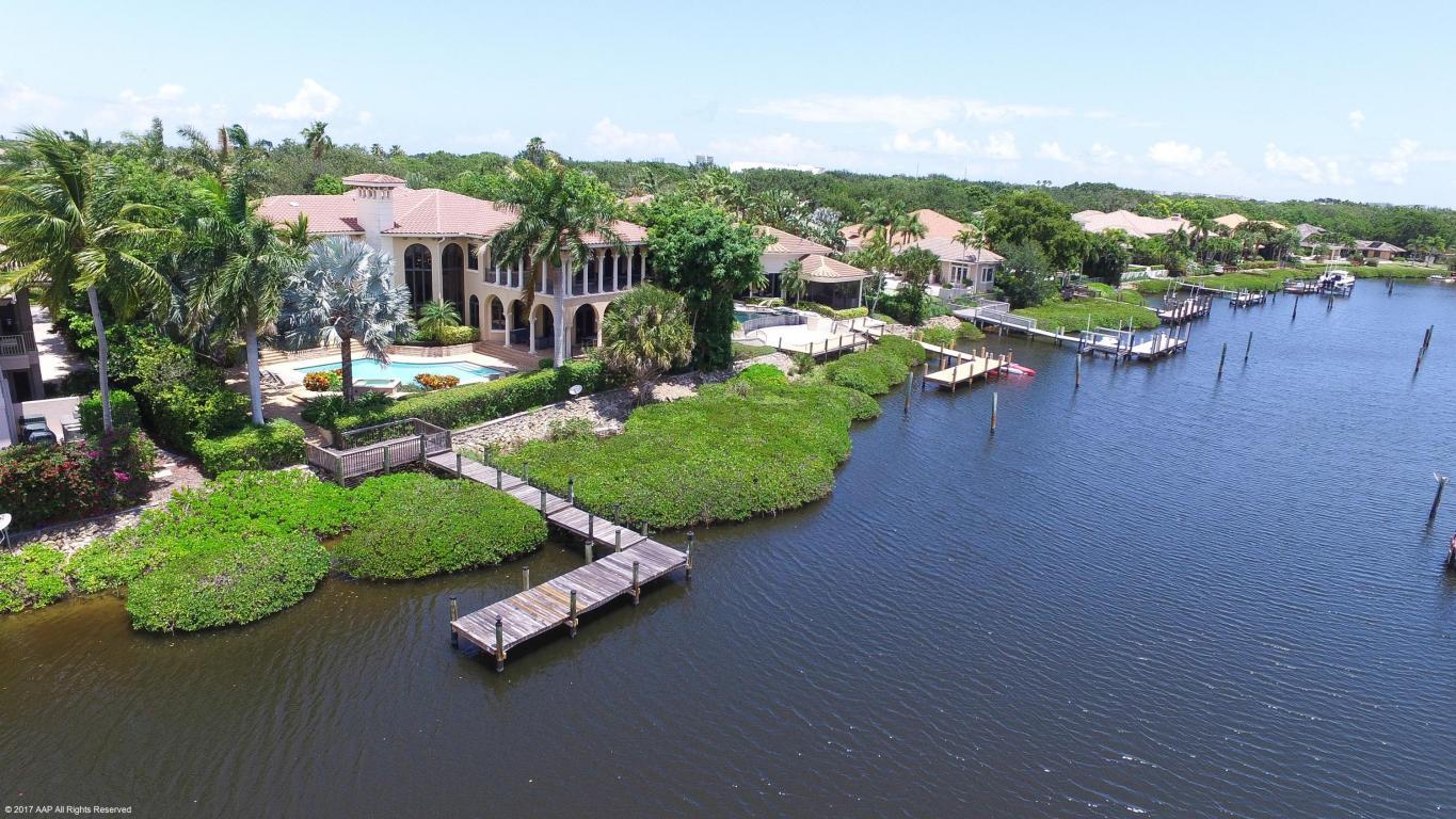 Spectacular custom waterfront estate boasting 8,188 sq. ft. of exceptional living space and 10,315 total sq. ft. located on a quiet cul-de-sac close to clubhouse in highly desirable Admirals Cove. Home has expansive views and water vistas and can accommodate up to an 80 ft boat -Direct intracoastal and ocean access within minutes! This beautifully appointed estate built in 2005 has only the finest craftsmanship and materials including impact glass and marble floors throughout. Grand entry opens to formal Master suite has private 13 x 13 sitting rm, his and her baths, fitted closets, washer/dryer, breakfast bar w/refrigerator and balcony. 5 zone A/c, exercise room, partial house generator, covered loggia 31/23 w/outdoor kitchen 1st floor In-law suite w/kitchen and bath
Required golf membership conveys all the 1st class amenities of Admirals Cove --2 clubhouses, 45 holes of golf, restaurants, tennis courts, new marina w/floating docks