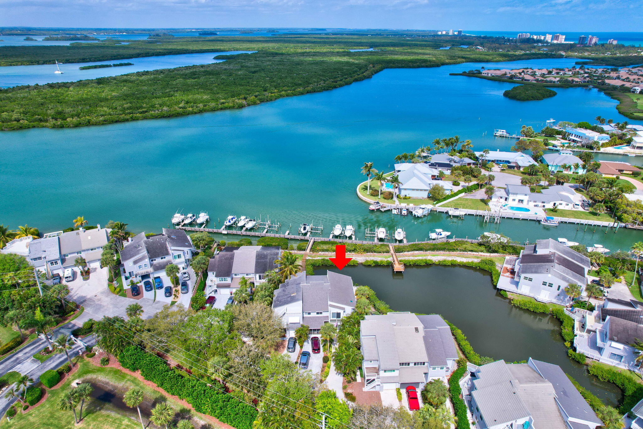 Wait until you see the breathtaking water views from this stunning townhome—one of the best in the entire community with a private 30' boat dock and lift.  Bring your boat and enjoy the luxury of a private dock with a lift—a rare find and the only townhome listed with a dock & lift in the highly sought-after Harbour Cove on Hutchinson Island that offers this exclusive feature.  This beautiful corner unit has All IMPACT windows and Doors AND a newer roof!  Step inside, and you'll be immediately surrounded by panoramic water views. The open floor plan seamlessly connects the family room, dining area, and kitchen, with two sets of sliders leading to a wrap-around patio and a covered, screened-in porch perfect for enjoying the breeze. Upstairs, you'll find two spacious bedrooms, including a primary suite with stunning views, plus two full baths and an indoor laundry area (not in the garage!). With all impact windows and doors, a brand-new deck and railing, and low HOA fees, this home truly has it all!  Don't miss your chance to own this exceptional waterfront retreat schedule your showing today!
