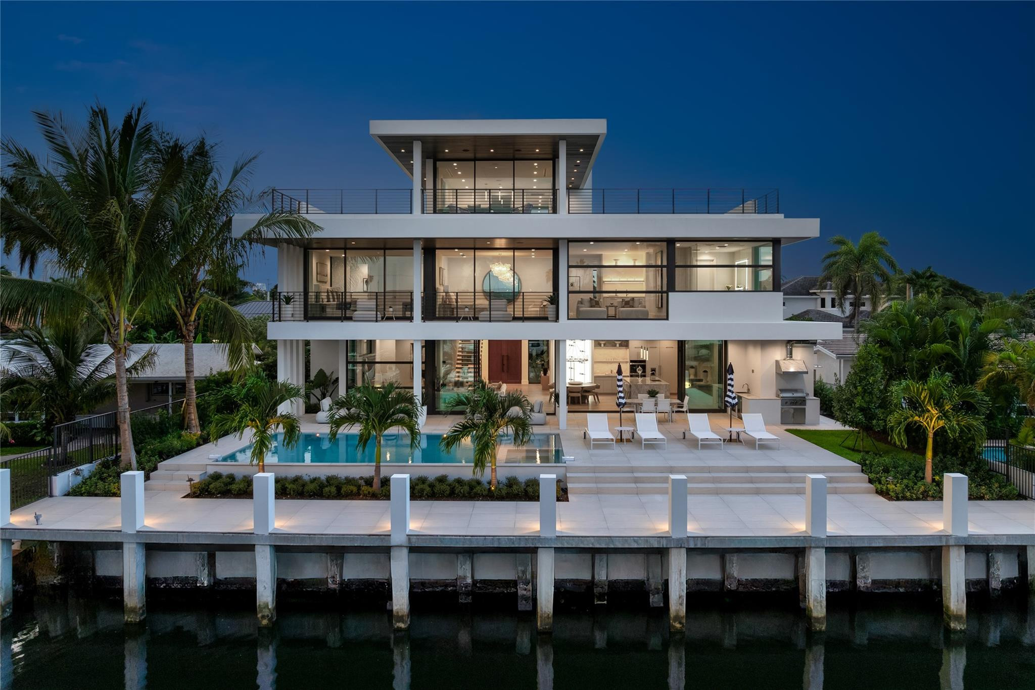 An exceptional new modern waterfront home delivering the ultimate in luxury, design, and yachting lifestyle. Newly completed by Stenmark Builders and designed by Slate Development, this residence offers 80 ft of deep-water frontage on a deep wide canal, no fixed bridges, ocean access in minutes. Elevated above required standards with a brand-new concrete seawall and dock. Features 5 en-suite bedrooms, 8 baths, and a 3-car garage with lift capacity for up to 6 vehicles. 3-story entry with water views, natural light, and an under-lit floating staircase. Top of the line-Miele kitchen with gas stove, butler's pantry, and wine closet. 10-ft sliders open to heated salt-water pool, jacuzzi, summer kitchen, cabana bath, and an outdoor shower. Buyer to verify all measurements.     An exceptional modern waterfront masterpiece delivering the ultimate in luxury, design, and yachting lifestyle. Newly completed by Stenmark Builders and designed by Slate Development, this residence offers 80 ft of deep-water frontage on a wide deep water canal with no fixed bridges and ocean access in minutes. Elevated above required standards with a brand-new concrete seawall and dock. Features 5 en-suite bedrooms, 8 baths, and a 3-car garage with lift capacity for up to 6 vehicles. Dramatic 3-story entry with water views, natural light, and an under-lit oak floating staircase. Miele kitchen with gas stove, butler's pantry, and wine closet. 10-ft sliders open to heated salt-water pool, jacuzzi, summer kitchen, cabana bath, and outdoor shower. Private elevator. Expansive 3rd floor balcony with downtown Fort Lauderdale skyline views. Buyer to verify all measurements.
