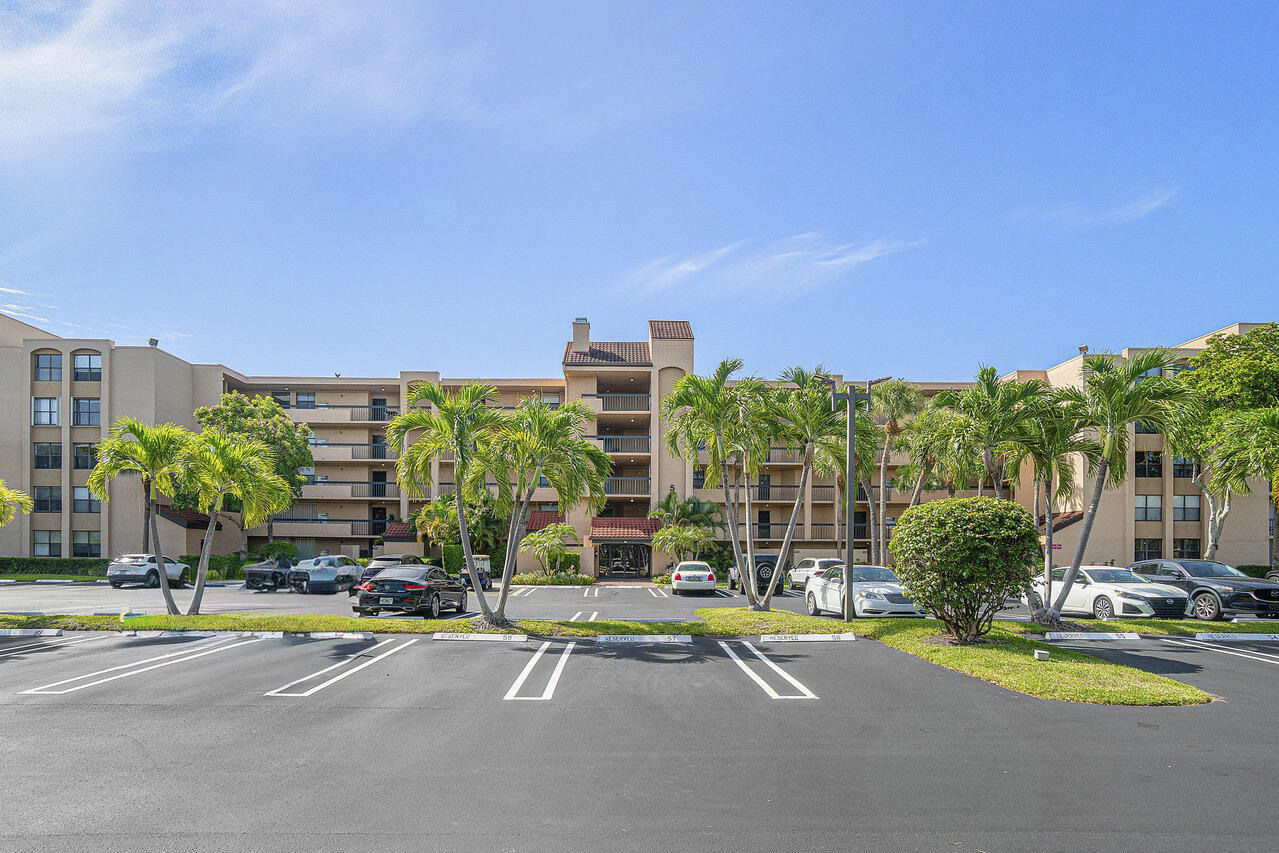 Discover the perfect blend of comfort, style, and convenience in this 2 bed/ 2 bath corner unit in highly sought-after Delray Racquet Club. Open floor plan enhanced by upgraded kitchen with granite counters, stainless steel appliances, tray ceiling, recessed lighting, and extended breakfast bar with seating. Split bedroom layout for privacy. Both beds offer walk-in closets and updated baths. Separate laundry room has full size washer-dryer. Screened patio with accordion shutters for inclement weather. Tranquil water views. Resort-style amenities. Ideal as full-time residence, seasonal retreat, or investment opportunity. Rentals permitted up to 6 times per year for minimum 30 days. Prime location one mile to beach just blocks from Whole Foods, Target and Home Depot.