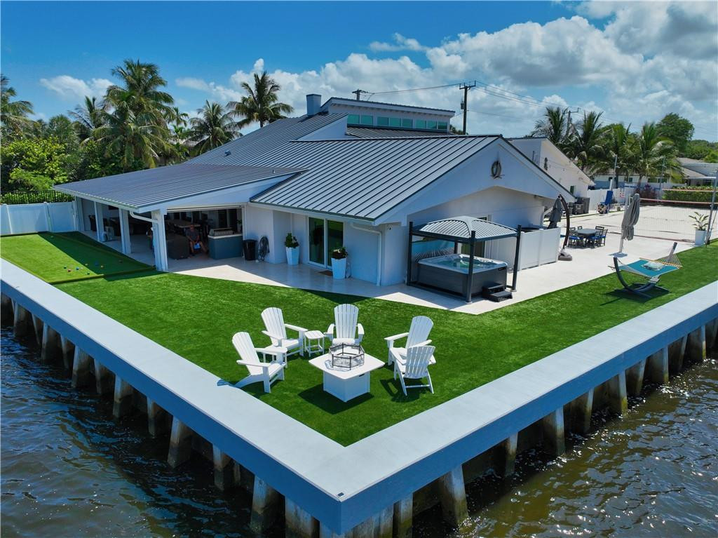 Stunning, one-of-a-kind Dream Home offering a Double Point Lot on the Intracoastal Waterway. Complete renovation in 2021 including New Roof, Windows, Stunning Designer Kitchen, Top of the Line Appliances, A/C, Whole House Generator, NEW 2021 raised Concrete Seawall, Security Cameras and Gated Front Entrance. This home has 5 large bedrooms + office. 3 Master Suites (2 on the first floor) and 6 bathrooms. The covered patio area offers an up-close feel to the ICW and includes retractable screens, bar area and Summer outdoor kitchen. The oversize heated saltwater pool and separate spa and recreation areas complete the back yard Double Jet Ski Lift, Boat Lift, This Stunning Home offers a fabulous lifestyle w/ amazing outdoor living and entertaining space. 30 amp RV hook up.