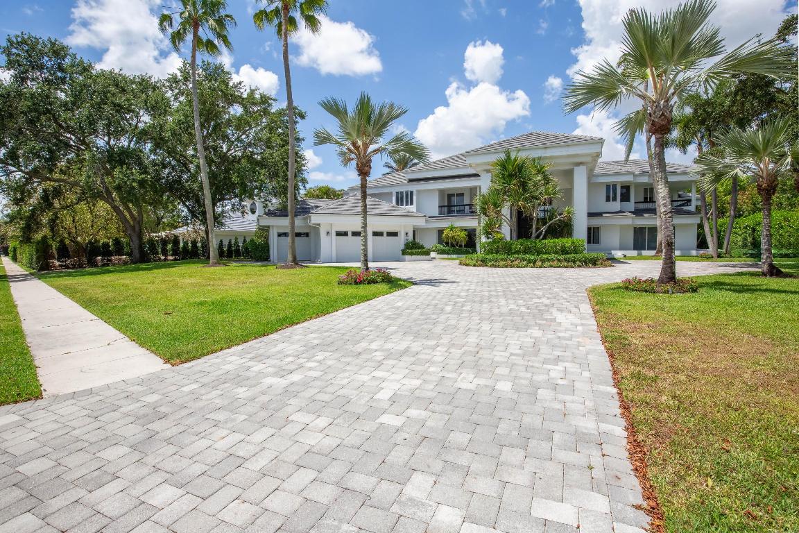 Timeless elegance in Palm Beach Polo & Country Club! This 6BD/6.1BA estate offers over 8,300 sq ft of luxury on a private .83-acre waterfront lot. Soaring ceilings, impact glass, and serene views set the tone throughout. Highlights include a chef's kitchen, grand living spaces, a spacious loft, media room, office, and a 24' x 30' primary suite. Outside, enjoy a heated pool/spa, lush landscaping, and multiple patios—perfect for entertaining. 3-car garage, elevator, and smart security. No membership required.