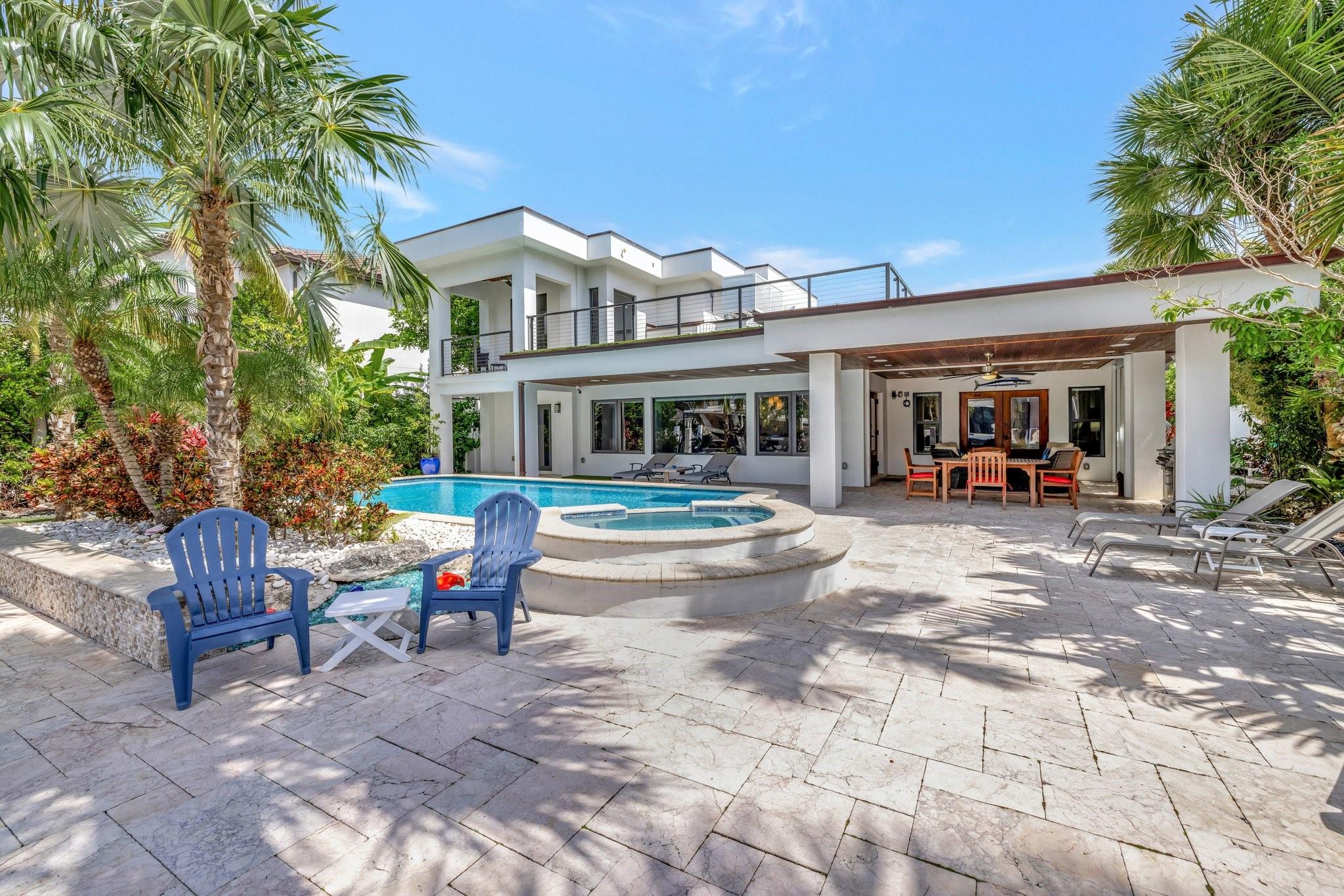 Located in the prestigious, guard-gated Seven Isles with 24/7 security patrol, this fully remodeled (2018) 4BD/4.5BA waterfront home offers 76 feet on a wide canal with a boat lift, ocean access, and no fixed bridges. With 3,766 sq ft of living space, it features two expansive primary suites—one up, one down—ideal for guests or multigenerational living. Enjoy a resort-style pool, spa, lush subtropical landscaping, whole-house generator, and chef’s kitchen. Close to the beach and Las Olas from this prime Fort Lauderdale location. Designed for both elegance and function, the open floor plan is ideal for entertaining, with light-filled living spaces that flow effortlessly to the outdoors. Minutes from world-class shopping, dining, this home is the complete South Florida lifestyle package. Exceptional Waterfront Living in Guard-Gated Seven IslesExperience refined coastal living in this fully remodeled 4-bedroom, 4.5-bathroom residence, ideally situated in the exclusive, guard-gated enclave of Seven Isles—just moments from the beach and famed Las Olas Boulevard. Boasting 76 feet of deepwater canal frontage with a boat lift, this property offers direct ocean access with no fixed bridges, making it a boater’s paradise.Completely reimagined in 2018, the home spans 3,766 square feet of interior space and is designed for both elegant entertaining and relaxed everyday living. A thoughtful floor plan offers two expansive primary suites—one upstairs and one on the main level—providing exceptional flexibility for multigenerational living, guests, or seasonal hosting.The heart of the home is a light-filled chef’s kitchen featuring custom cabinetry, premium appliances, and a large island that flows seamlessly into the open living and dining areas. Soaring ceilings, refined finishes, and walls of glass invite the outdoors in, creating a seamless connection between interior luxury and South Florida’s iconic outdoor lifestyle.Step outside to your private tropical oasis, where lush landscaping surrounds a resort-style heated pool and spa. The wide canal offers peaceful views and accommodates a variety of vessels, with a boat lift already in place for your convenience. Whether you’re setting out for a sunset cruise or entertaining guests dockside, this home offers the best of waterfront living.Additional features include a whole-house generator, impact windows and doors, smart-home systems, custom lighting, and a two-car garage. Security and peace of mind come standard with 24/7 roving patrol in this sought-after gated community.Enjoy the rare opportunity to live in one of Fort Lauderdale’s most prestigious neighborhoods, where privacy, security, and walkability converge. Stroll to the white sands of Fort Lauderdale Beach or explore the world-class dining, shopping, and cultural offerings of Las Olas—all just minutes from your doorstep.Whether you’re seeking a primary residence, a seasonal escape, or a home that offers both luxury and functionality, this Seven Isles masterpiece delivers.