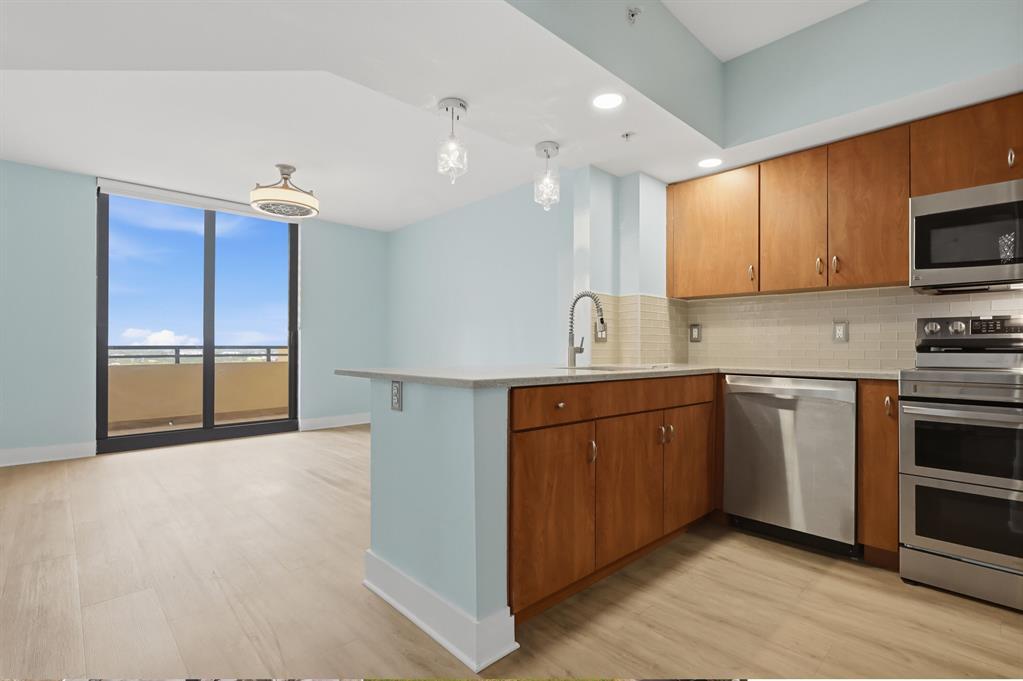 Rarely available one-bedroom residence with den offering expansive north-facing views. The unit has been thoughtfully updated and is move-in ready. Features include a spacious primary bedroom with a walk-in closet, a large bathroom, private balcony, impact-rated glass, and in-unit laundry. The open kitchen provides ample storage and counter space. Building amenities include a city-facing pool and spa, fitness center, club room, doorman, garage parking, valet service, and more.