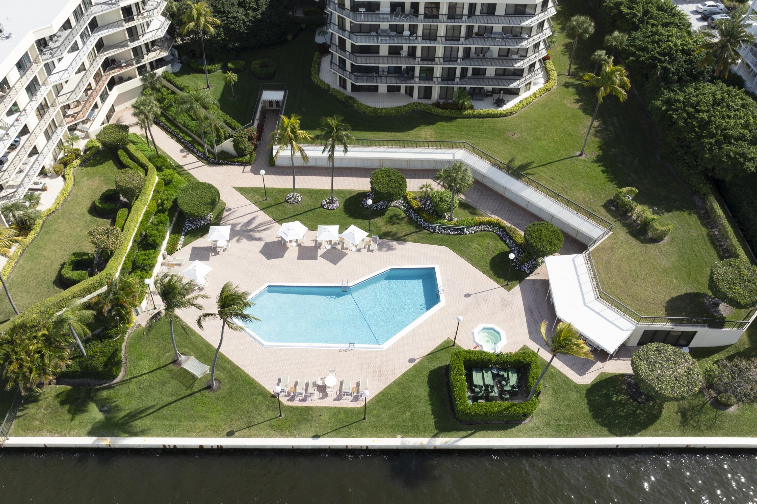 Experience refined coastal living in the heart of Palm Beach with this exceptional waterfront condominium, ideally situated within one of the area's most desirable full-service buildings. Combining luxury, comfort, and value, this residence offers a rare opportunity to enjoy a high-end lifestyle at a reasonable price point in a market known for its exclusivity and strong demand for amenity-rich properties.  This beautifully appointed two-bedroom residence encompasses approximately 1,780 square feet of interior living space, complemented by an expansive 300-square-foot private balcony designed for seamless indoor-outdoor living. Floor-to-ceiling, hurricane-impact glass sliders in every room flood the home with natural light while showcasing sweeping waterfront views and providing direct  access to the oversized terrace—perfect for entertaining or relaxing in a serene coastal setting. The interiors have been thoughtfully updated with a brand-new kitchen featuring modern finishes and quality craftsmanship, along with new flooring throughout, creating a clean, contemporary aesthetic that is both elegant and functional. The generous layout offers spacious living and dining areas, well-proportioned bedrooms, and an overall sense of openness rarely found at this price level. Residents enjoy a full suite of resort-style amenities typically reserved for the most prestigious developments. These include a newly renovated fitness center, full-time doorman service, and a beautifully updated clubhouse that opens onto a stunning waterfront pool deck—an ideal setting for socializing or unwinding. The building also offers deeded beach access, allowing effortless enjoyment of Palm Beach's pristine shoreline, as well as secure garage parking for added convenience and peace of mind. Set along the waterfront with access to both ocean and Intracoastal lifestyles, this residence embodies the defining characteristics of luxury Palm Beach condominiums—prime location, expansive views, and comprehensive amenities—all within a well-maintained and highly sought-after community.