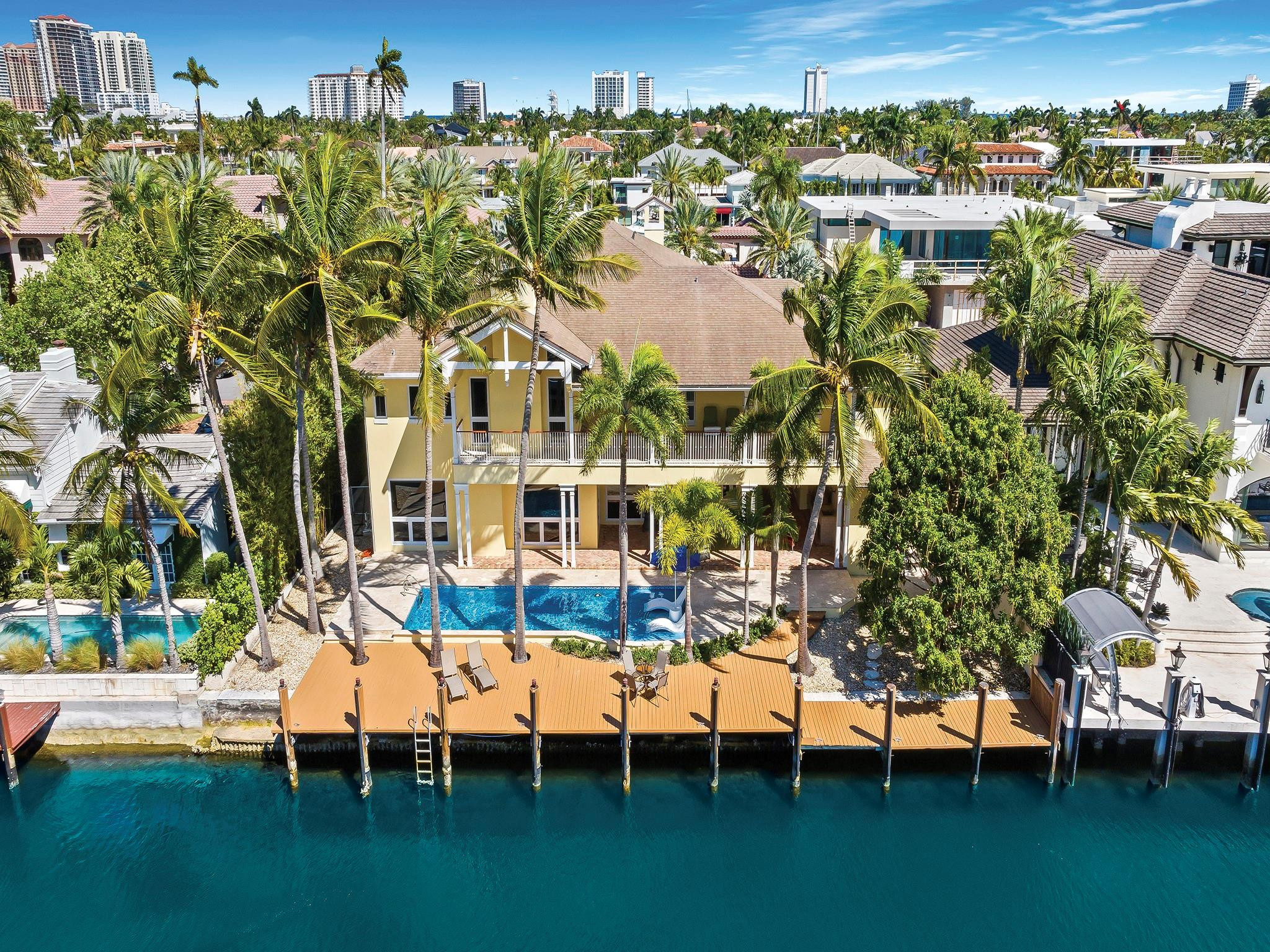 Luxury redefined in this transitional contemporary estate, situated in the southern waterways of the Las Olas Isles, boasting 100' of deep waterfront & no fixed bridges to the ocean. Unrivaled architecture, construction & attention to details for those who enjoy an elevated lifestyle. This luxurious residence is enhance by vaulted & coffered ceilings & large luminous spaces for entertaining. The gourmet kitchen will inspire those who love to cook. The lavish primary suite offers a sitting area, fireplace, spa inspired bathroom, walk-in closet & access to a waterside balcony. Additional details: separate guest quarters, a home office, 2nd floor family room, 1st & 2nd floor laundry rooms. A large lanai with summer kitchen overlooks the pool, patio and waterway. Sq ft from architectural plans