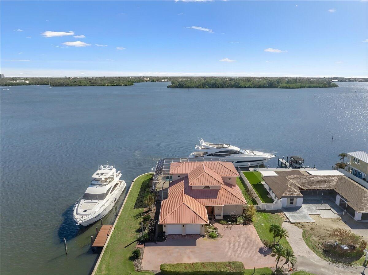 WELCOME TO VERO ISLES -- A BOATER'S DREAM

 Rare deep-water northeast riverfront point lot in the heart of Vero Beach. One of Vero Isles' best lots, this exceptional property offers over 200° of wide water views with direct access to the Indian River and Intracoastal, ideal for serious boaters. Just steps from the future Three Corners Project, this prime location combines privacy, convenience, and long-term value.

The solid concrete block 4BR/3BA/2-car garage pool home features a metal roof, impact windows, roll-down shutters on the second floor, and a whole-house generator for added peace of mind. A premier riverfront setting with deep water, expansive views, and endless potential.

*VIRTUALLY STAGED*