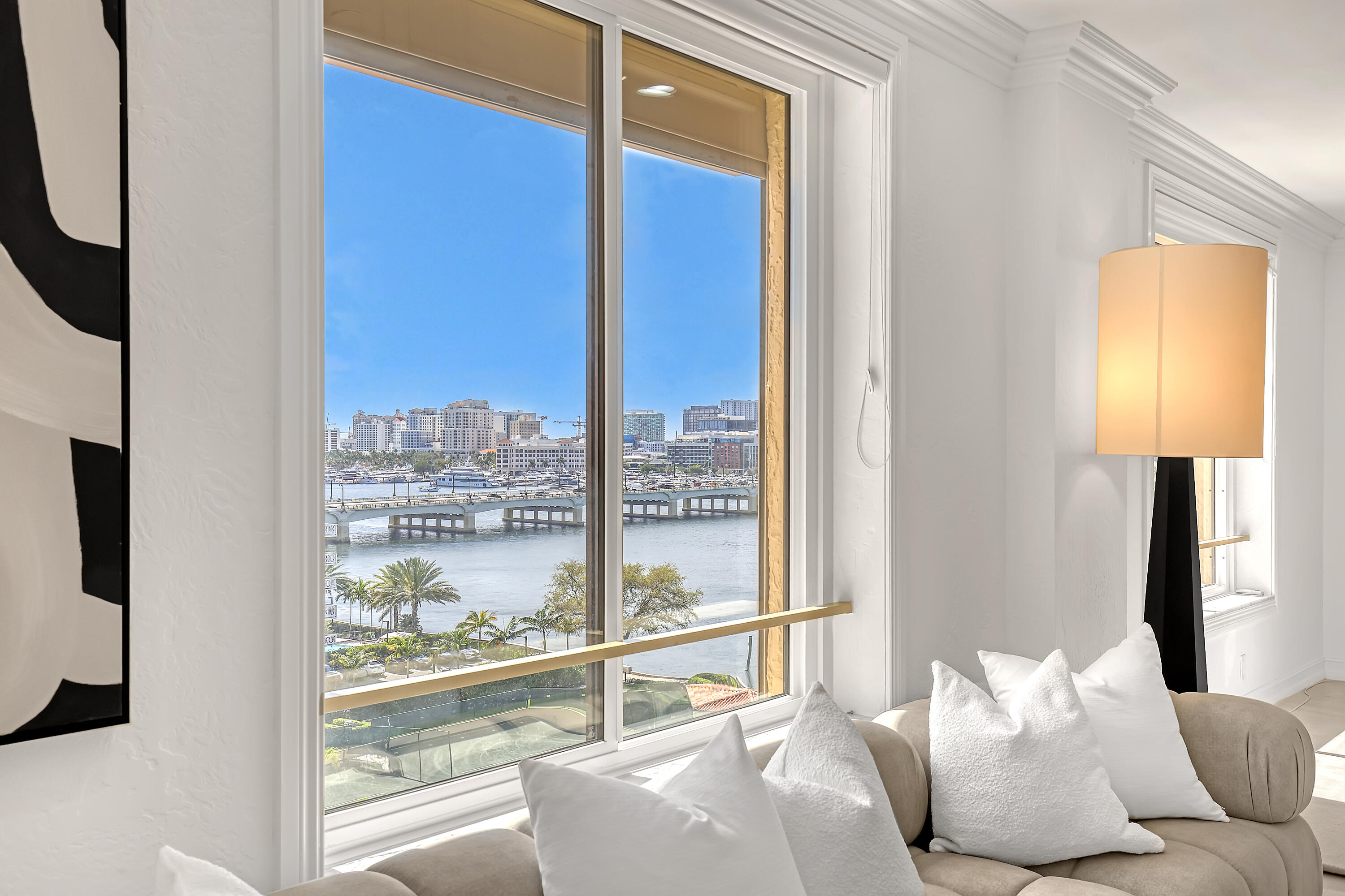Beautifully refreshed, this spacious 2-bedroom residence (easily convertible to a 3rd bedroom) at the iconic Palm Beach Biltmore offers over 1,800 sq ft of light-filled living. New impact windows, upgraded lighting, fresh paint, and polished tile floors create a clean, modern feel. Southern exposure fills the home with natural light and showcases sweeping Intracoastal, city, and garden views. The open living, dining, and kitchen areas are ideal for entertaining. The generous primary suite enjoys serene direct water and sunset views, while a flexible layout allows for either an expanded living space or a third bedroom. Residents enjoy premier amenities in a full-service building, including a private oceanfront beach club, Olympic-size pool, tennis courts and fitness center. Pet friendly too